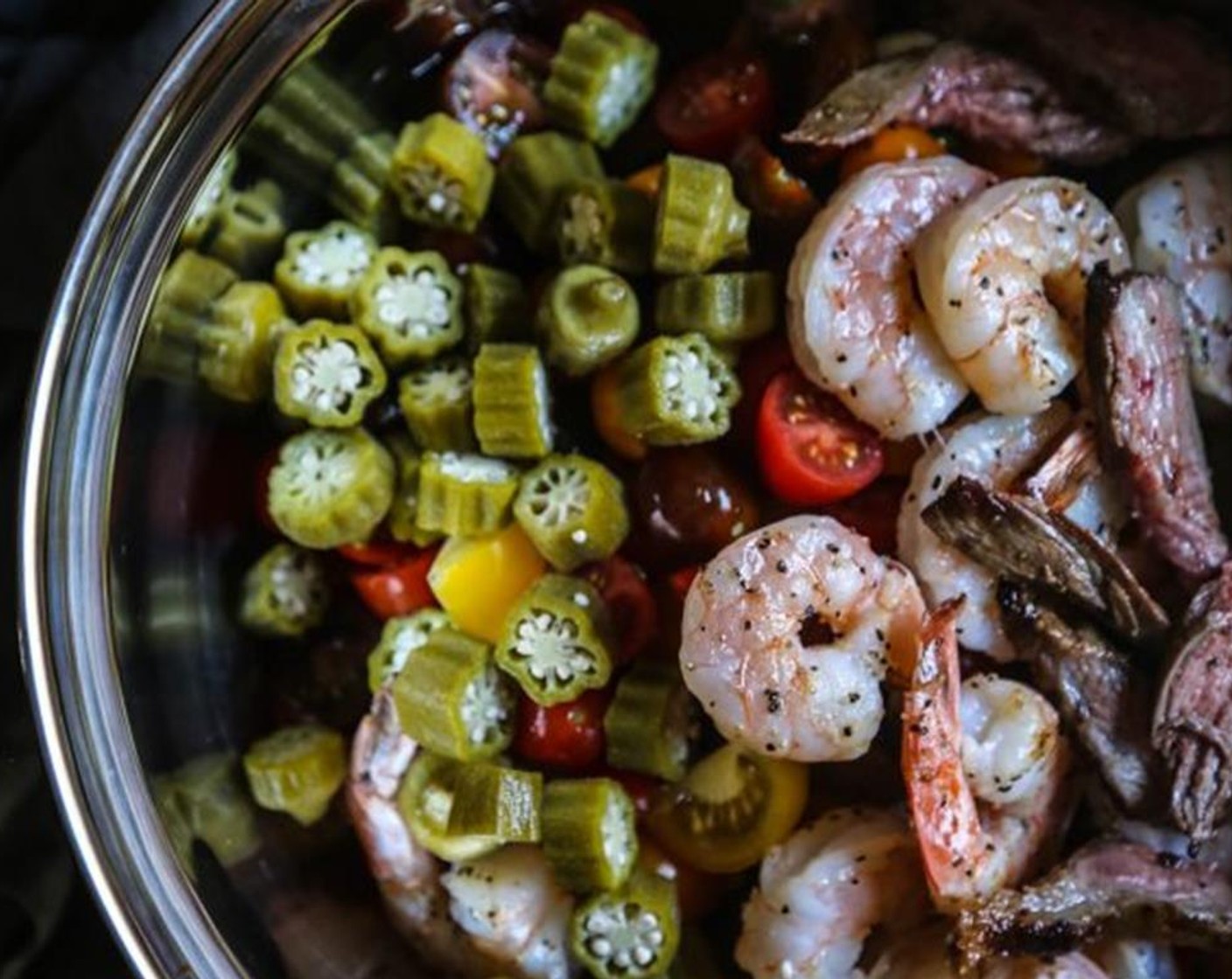 step 7 To make the salad, add croutons, Cucumbers (3 cups), Grape Tomatoes (4 cups), shrimp, Flank Steak (1 lb), Okra (1 cup), Red Onion (1 cup), Fresh Chives (to taste), Extra-Virgin Olive Oil (4 Tbsp), and Balsamic Vinegar (to taste). Season with salt and pepper.