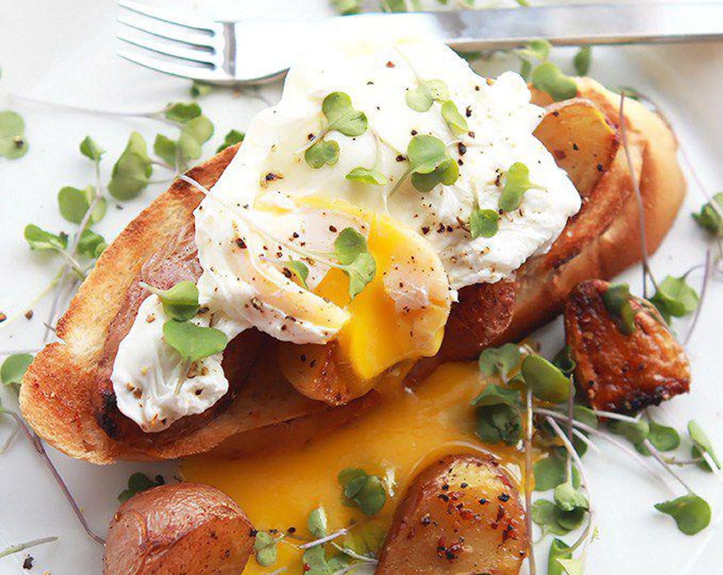 Poached Eggs Over Crispy Potatoes and Toast