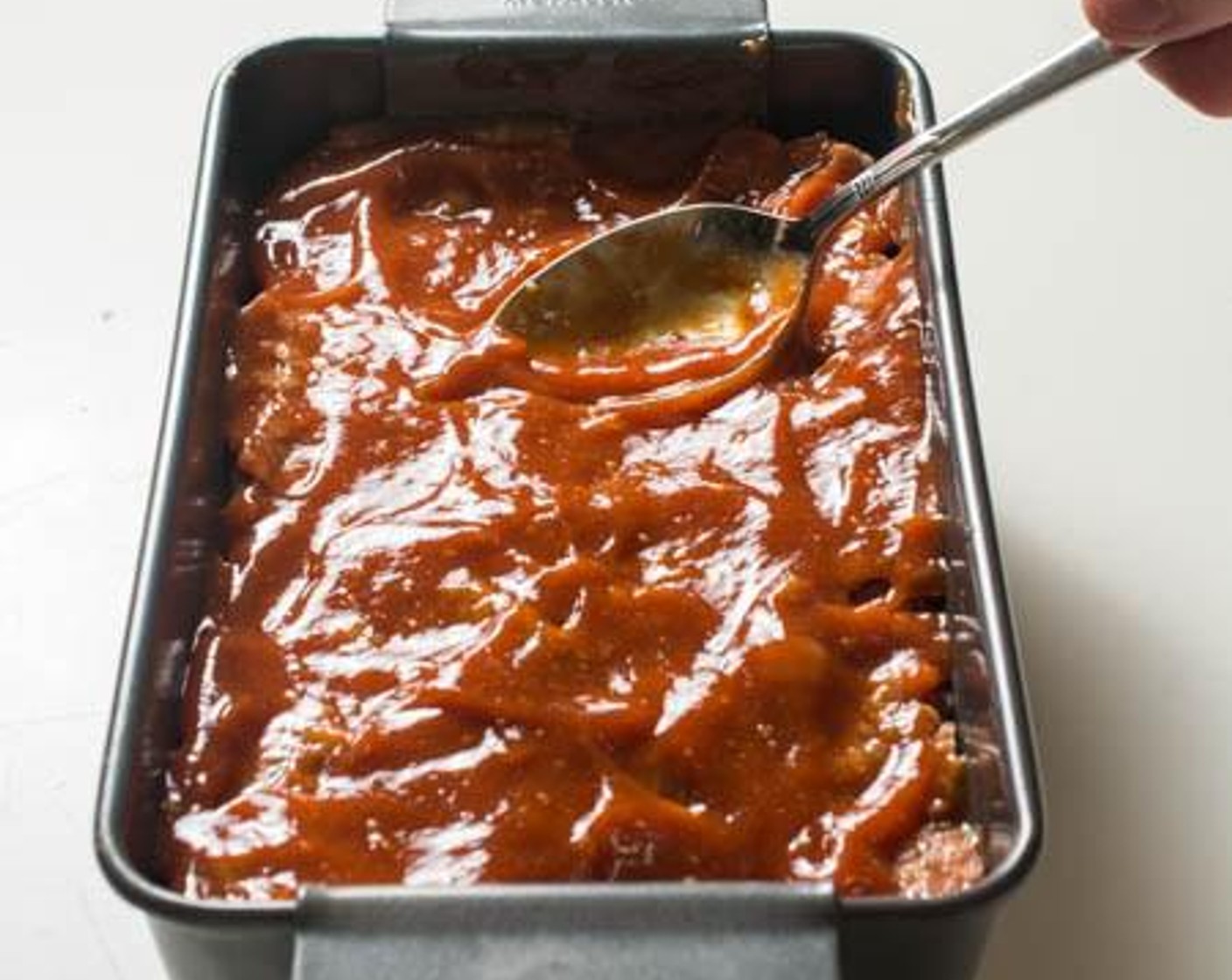 step 5 Set aside about 1/2 a cup of the sauce for dipping if you wish. Pour the rest of the sauce on to the meatloaf and use the back of a spoon to spread it evenly throughout the meatloaf's surface.