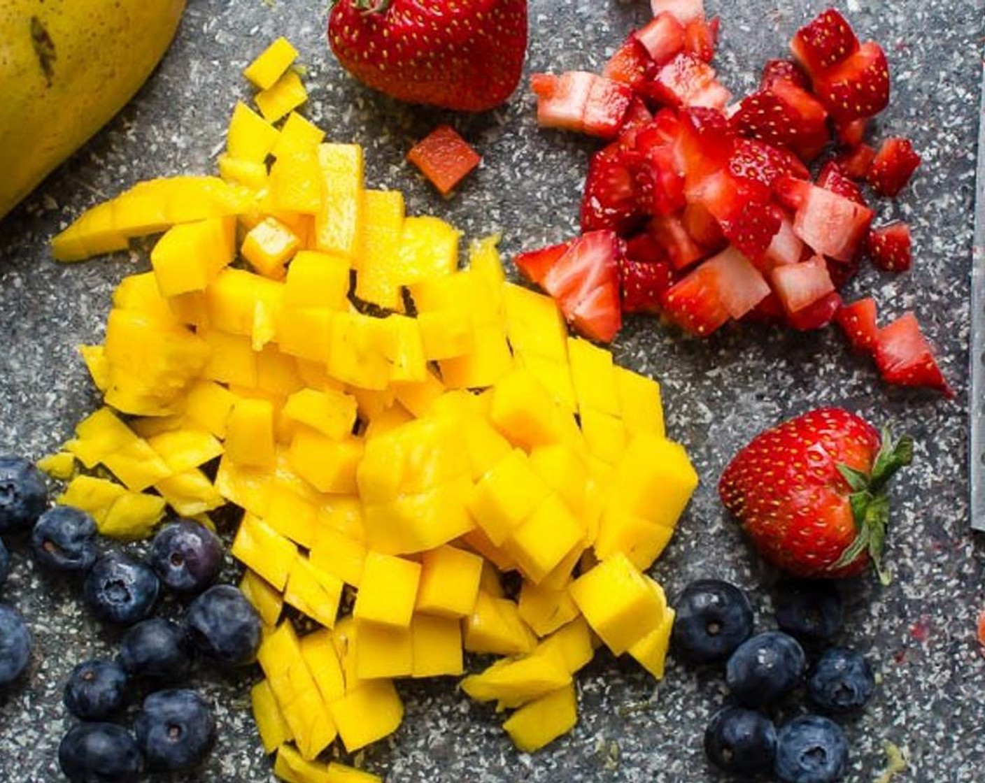 step 7 About 1 hour before serving, make the fruit salad. In a small bowl, combine the Mango (1/2 cup), Fresh Blueberry (1/2 cup) and Fresh Strawberry (1/2 cup). Sprinkle with Granulated Sugar (1/2 Tbsp) and Dark Rum (1 Tbsp) and toss to coat.