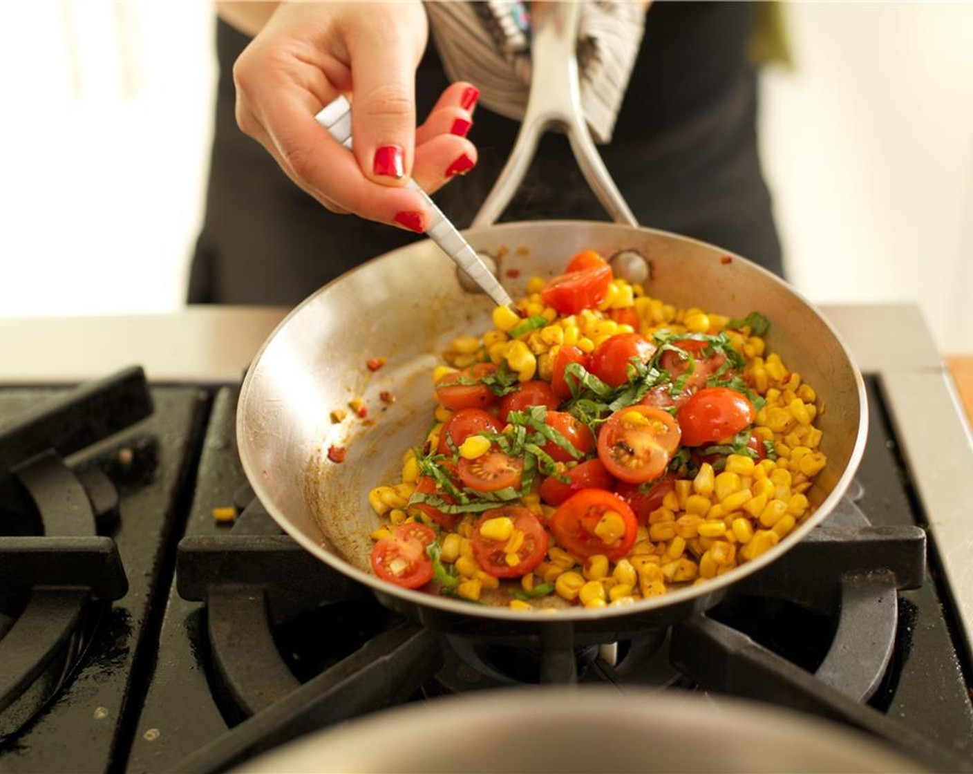 step 8 Over medium high heat, add Olive Oil (1 Tbsp) to a medium saute pan. When hot, add the corn mixture and saute for four minutes, stirring frequently. Remove from heat and add the cherry tomatoes and basil.