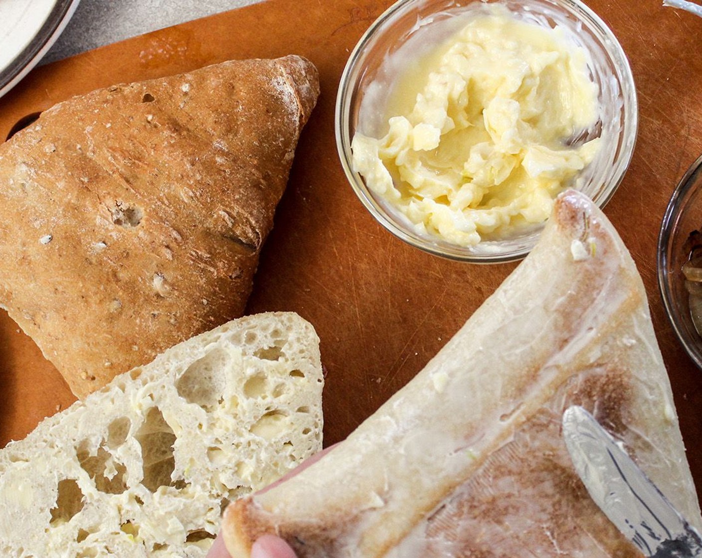 step 5 Spread the butter on the outsides of the Ciabatta Bread (2) avoiding putting the garlic bits on.