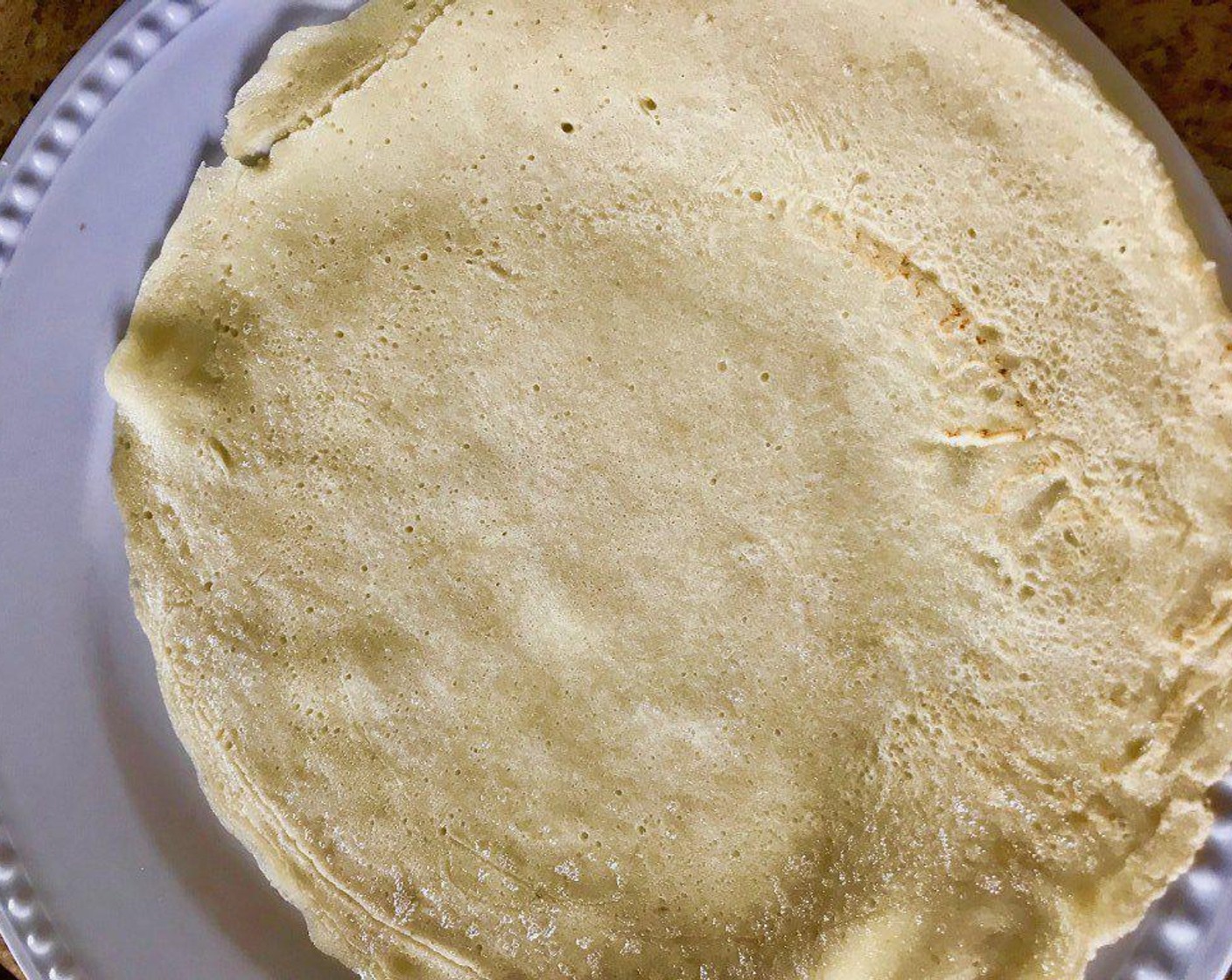 step 6 Grease the pan with more butter before making each additional crêpe.