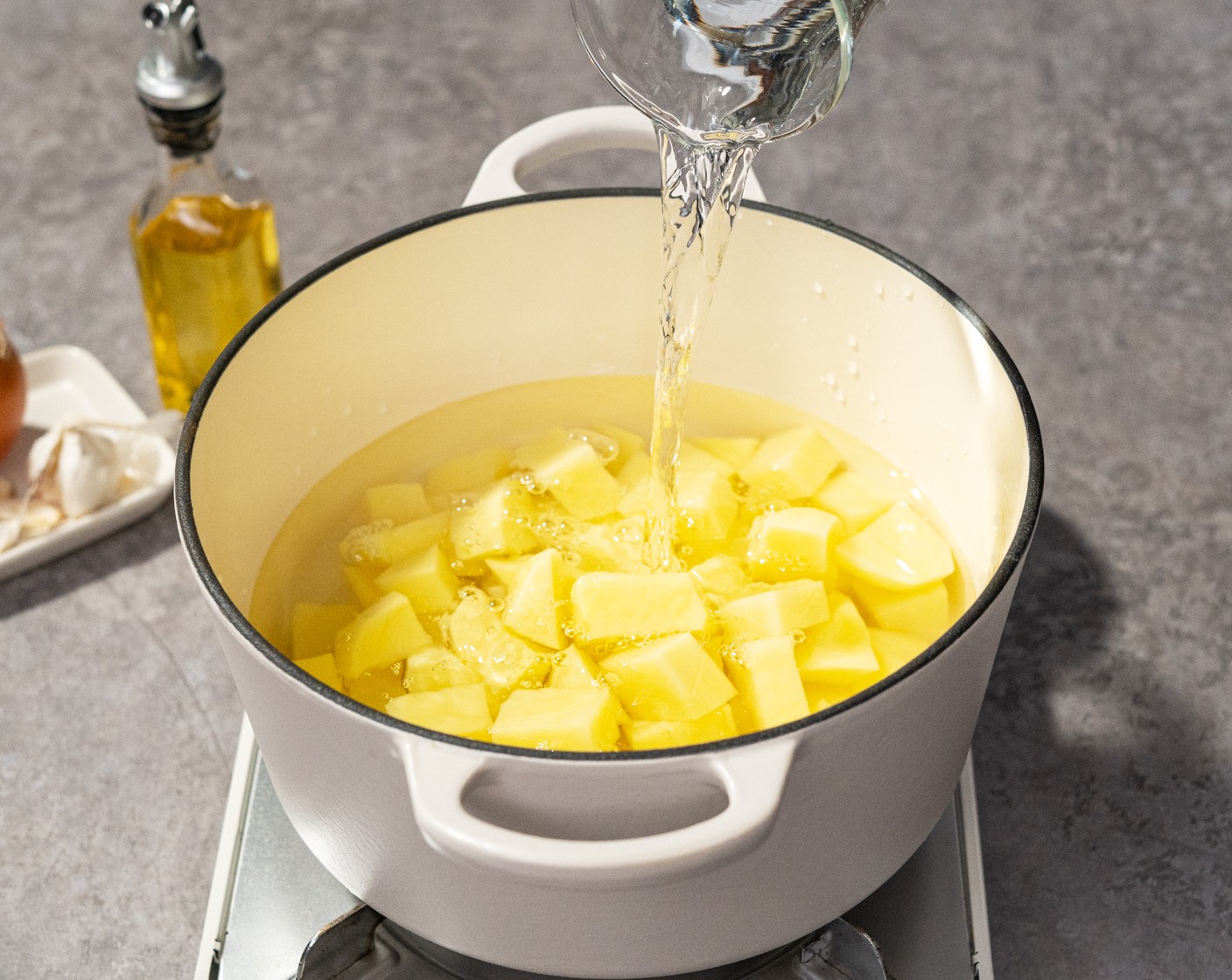 step 2 Place the Potatoes (3 lb) in the pot and cover them with Water (8 cups). Bring to a boil over high heat. Then turn to medium heat and cook until tender for about 15 minutes.