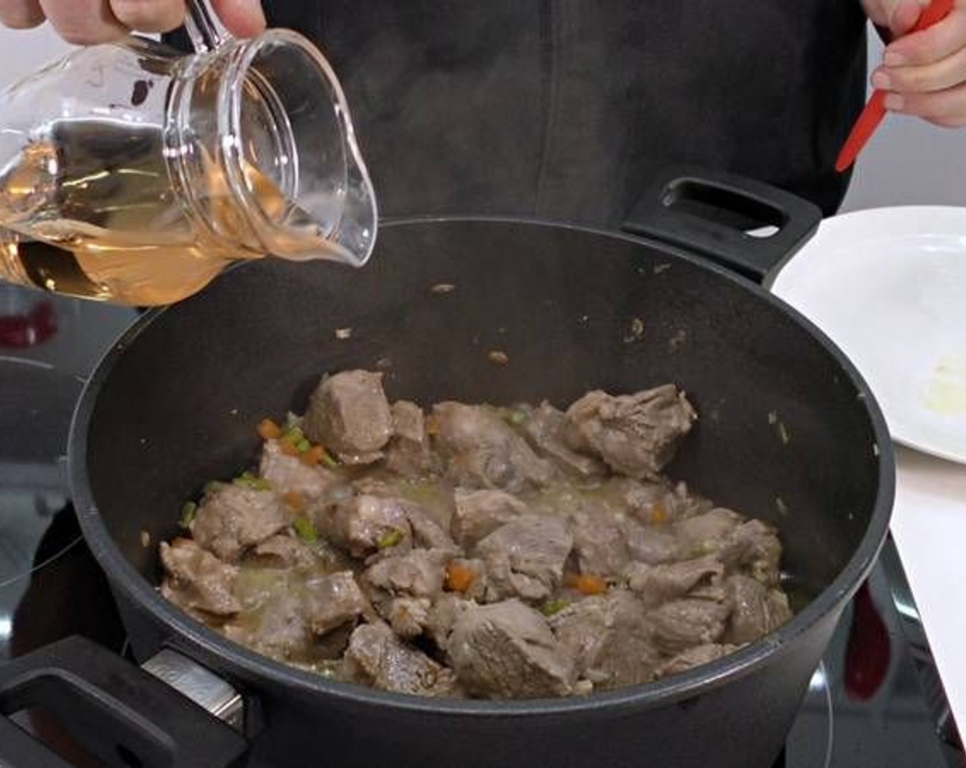 step 3 Once the lamb has browned add in the White Wine (to taste), Tomato Sauce (1/3 cup), and enough Water (as needed) to cover the meat.