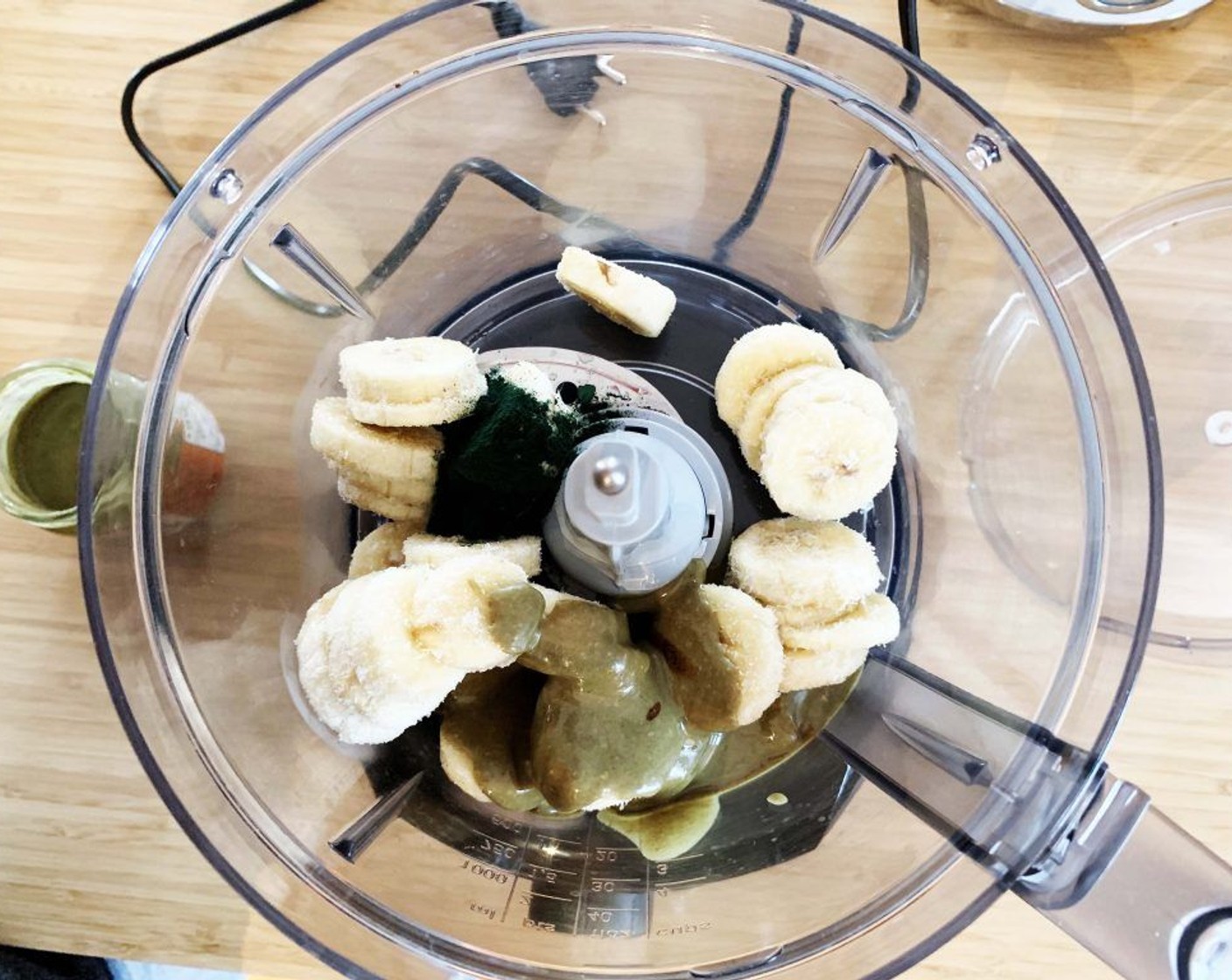 step 1 Place Bananas (2), Pumpkin Seed Butter (4 Tbsp), Vanilla Bean Paste (1/8 tsp) and Spirulina Powder (1/2 tsp) into a powerful food processor and pulse until creamy.