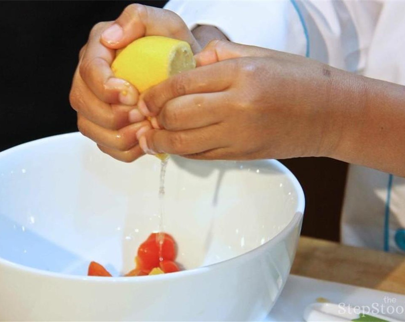 step 8 Place the cut tomatoes in a bowl. Halve and juice the Lemon (1) into the bowl.  Then add chopped basil, Extra-Virgin Olive Oil (3 Tbsp), Salt (to taste) and Ground Black Pepper (to taste).  Place aside until fish is cooked.