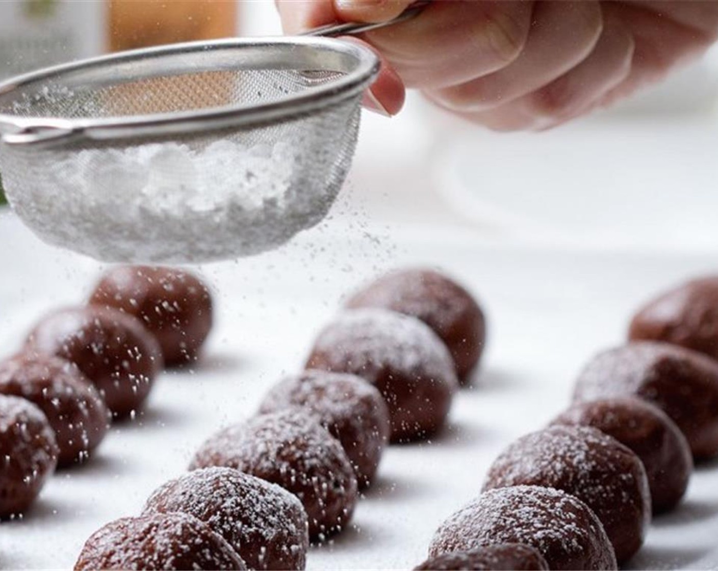 step 3 When the dough is fully mixed and slightly sticky, roll into balls. Place balls on a tray and sift additional Powdered Confectioners Sugar (to taste) over the balls.