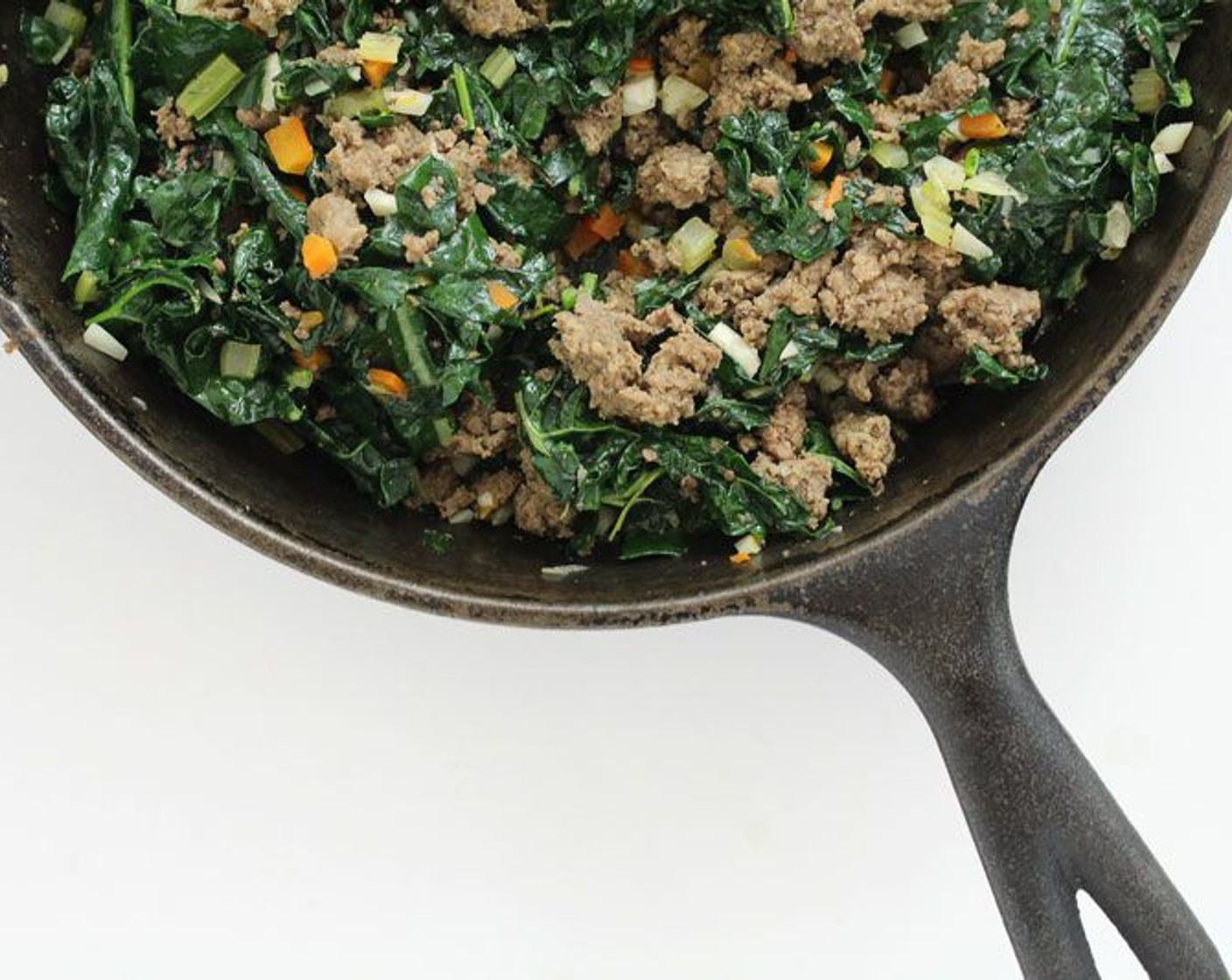 step 2 Cook the Ground Beef (1 lb) in a large skillet over medium high heat until partially done, then add the minced Garlic (4 cloves), diced Carrot (3/4 cup), Radish (3/4 cup), Celery (3/4 cup) and chopped Kale (3 cups). Cook for 5-10 minutes.