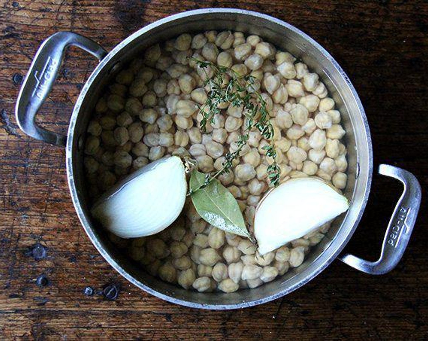 step 2 Drain chickpeas, rinse and place in a pot with the Onion (1), Fresh Thyme (3 sprigs), Garlic (1 clove), Bay Leaf (1) and Kosher Salt (1/2 Tbsp). Cover with water by three inches.