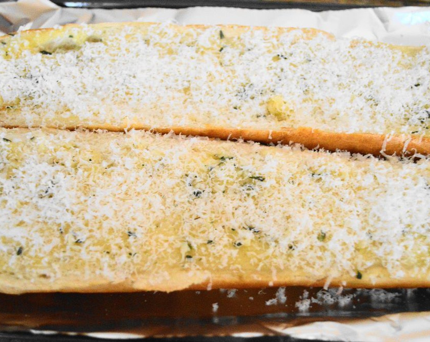 step 6 Evenly distribute a half cup of Parmesan Cheese (1 cup) on each half of the loaf.