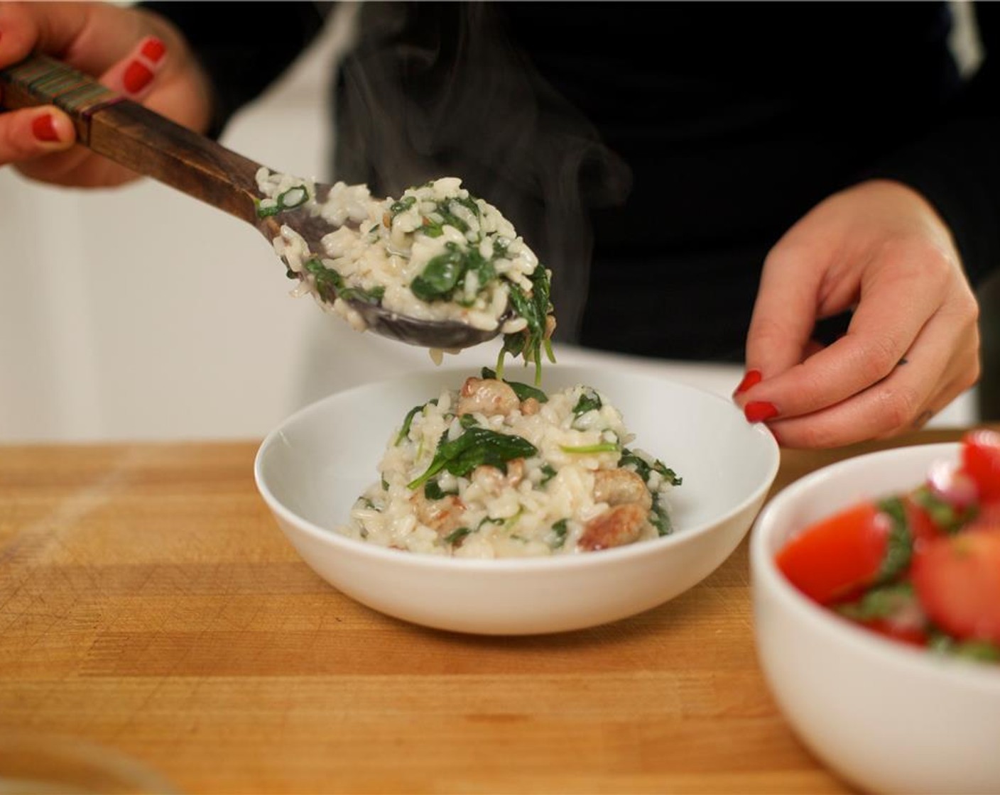 step 13 Scoop an even amount of risotto into two bowls. Serve the tomato salad on the side. Garnish the risotto with the lemon zest and chives.