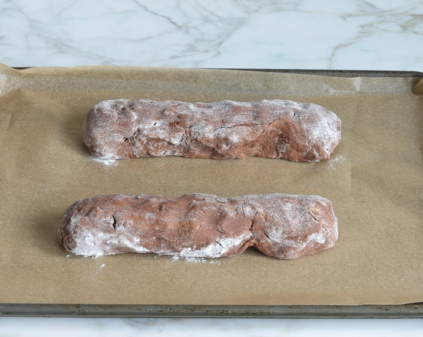 step 7 Form the dough pieces into two short logs by rolling back and forth.