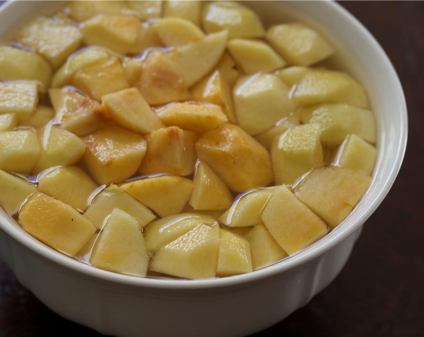 step 1 Preheat oven to 400 degrees F (200 degrees C). Cube the Apple (1) into half-inch pieces. Place them in a bowl of acidulated water (water with a tablespoon of lemon juice added to it. This keeps the apple from oxidizing while you prepare the other ingredients). Set aside.