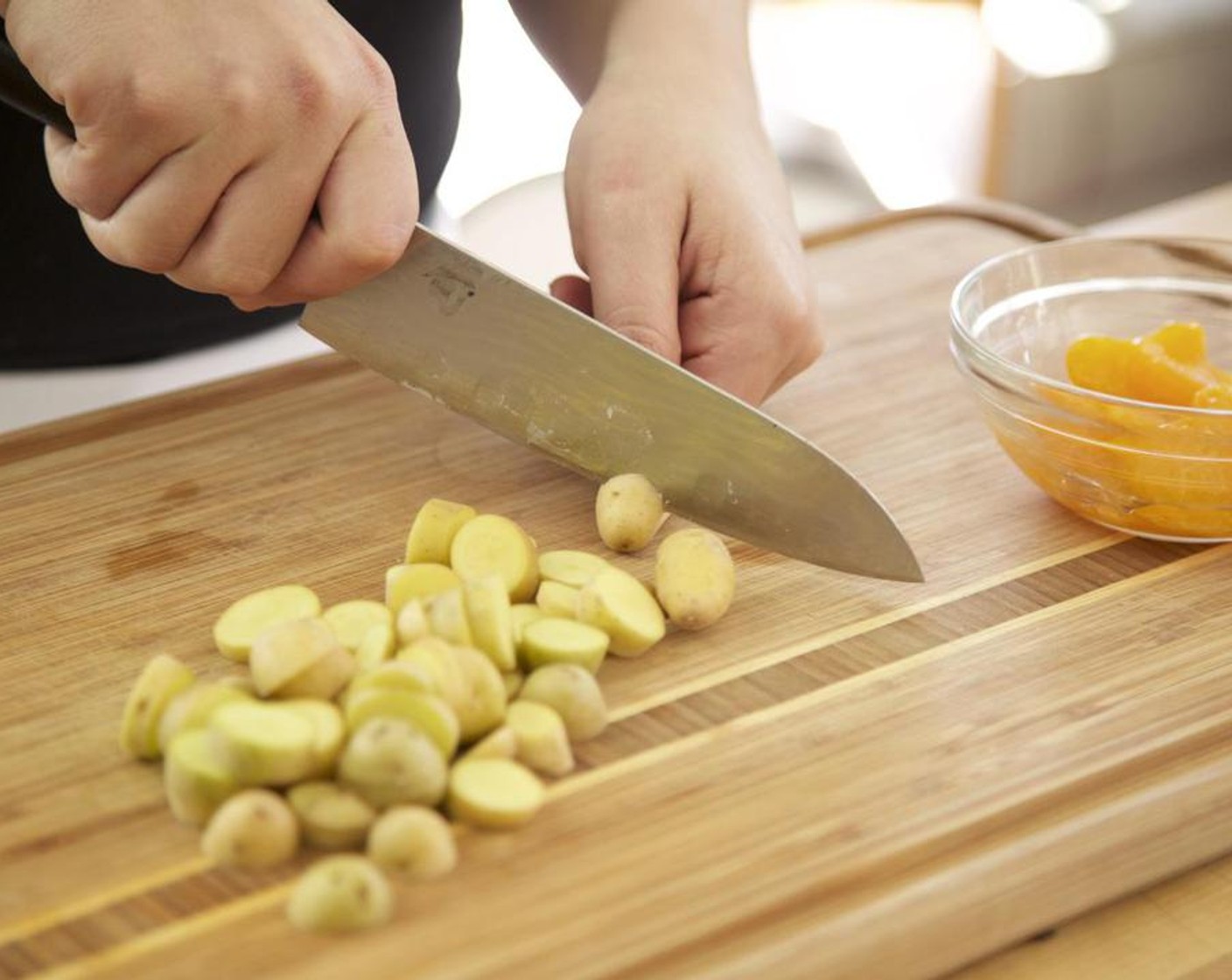 step 2 Cut the Fingerling Potato (3/4 cup) into 1/4 inch discs and place on a sheet pan. Mince Shallot (1); set aside. Thinly slice the Garlic (2 cloves); set aside. Juice half of the Lemon (1) into a small bowl; discard seeds; hold.