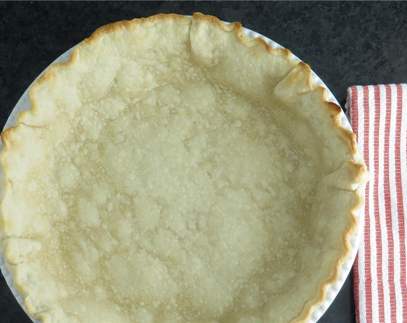 step 3 Place pie plate into the oven, and bake pie crust 6-7 minutes until set and just starting to brown. Remove crust from oven, and set aside. Reduce oven temperature to 325 degrees F (160 degrees C).