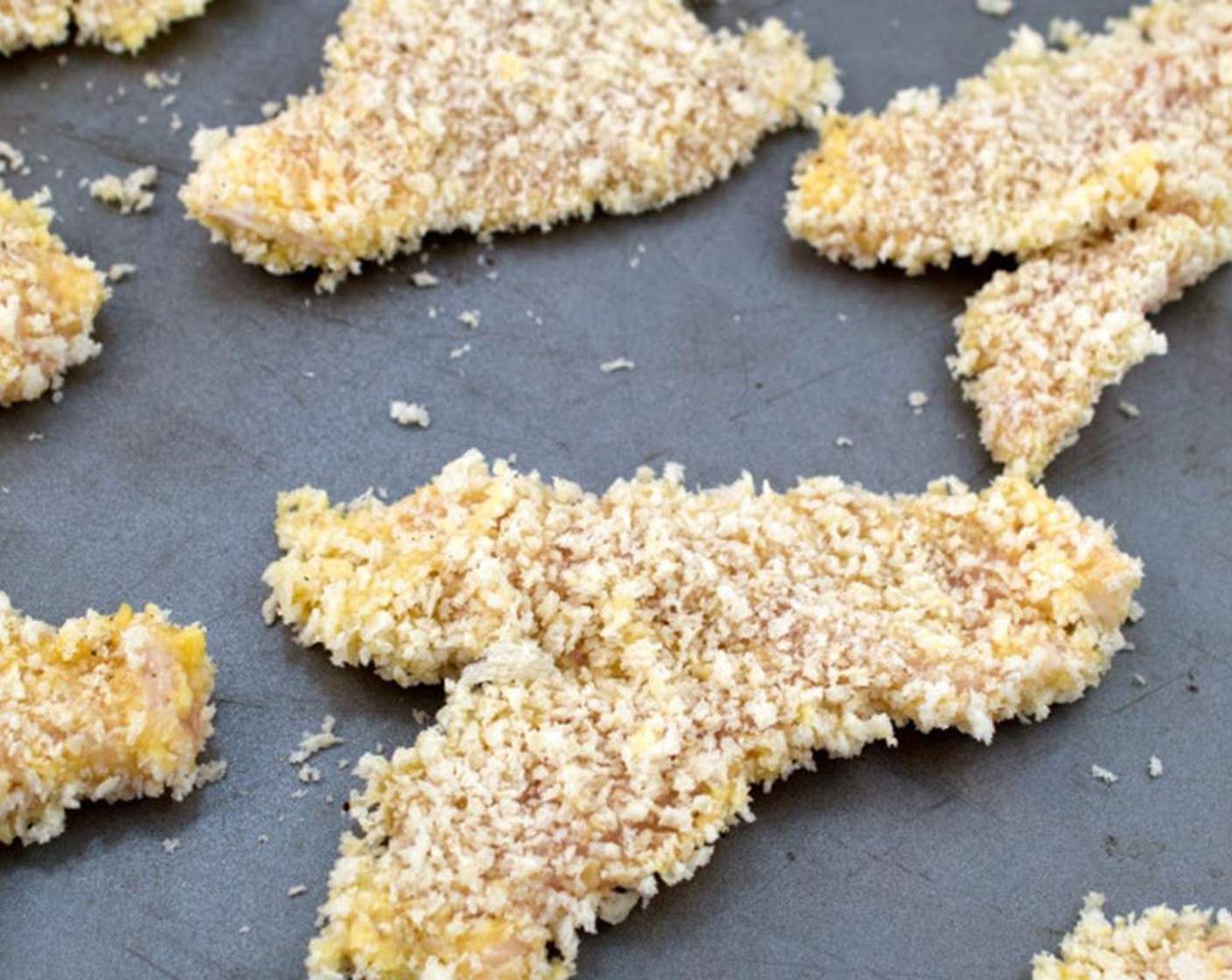 step 7 Transfer chicken tenders to a baking dish and place in the oven at 400 degrees F (200 degrees C), cooking for about 15 minutes or until golden brown and not pink on the inside. Make sure to flip the chicken tenders halfway through.