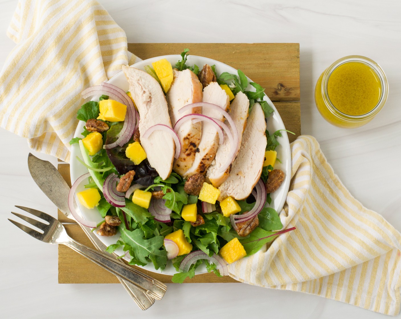 step 6 Slice the chicken breasts across the grain and place one breast on top of each plate. Serve warm or at room temperature.