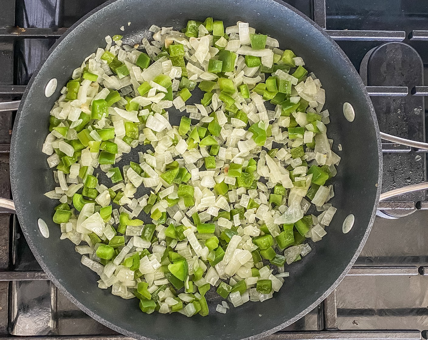 step 1 In a large non-stick skillet, heat Olive Oil (1 tsp) over medium-high heat. Add the Yellow Onion (1) and Green Bell Pepper (1) and cook for 5 minutes.