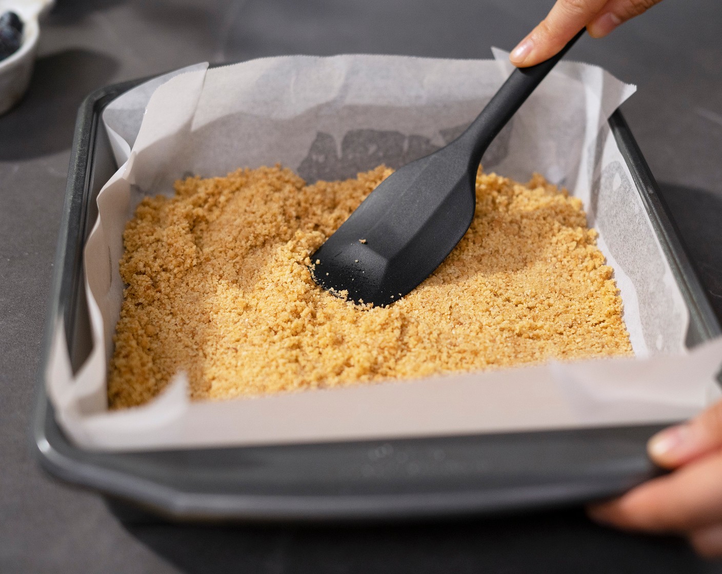 step 3 In a mixing bowl, mix the Digestive Biscuits (1 2/3 cups), Butter (4 Tbsp), Granulated Sugar (1 Tbsp), and Salt (1 pinch) until well combined. Transfer to the lined baking pan, and press the mixture into the bottom of the pan.