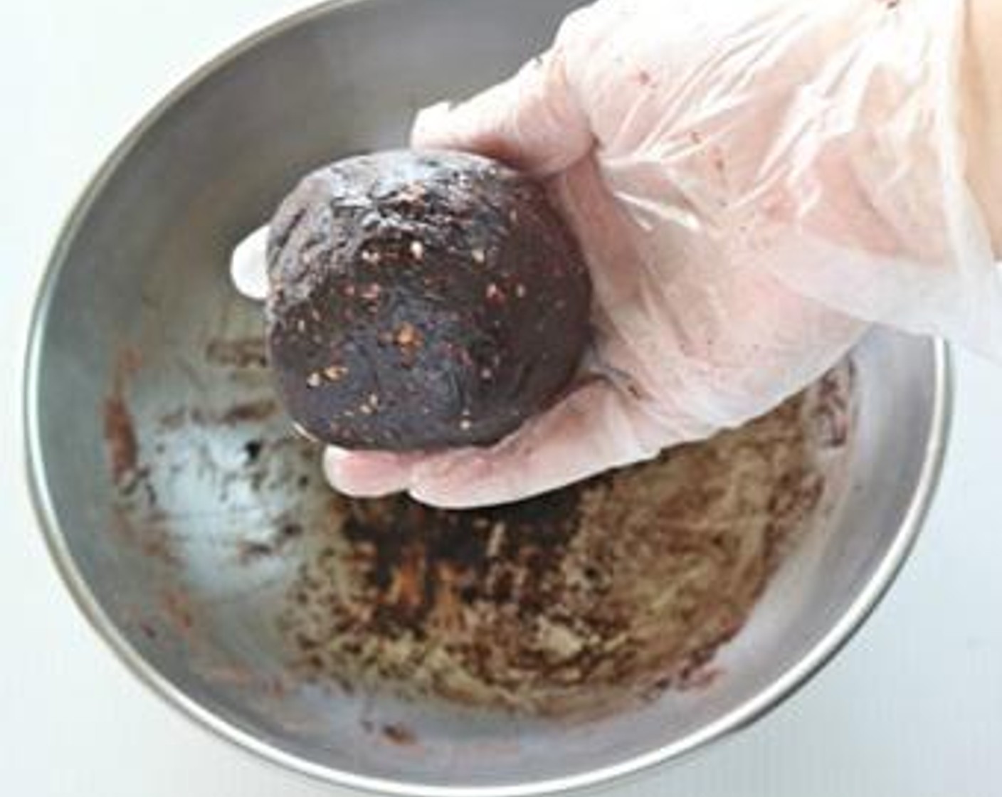 step 2 Make the filling by combining Unsweetened Cocoa Powder (1 cup), Assorted Nuts (1/2 cup), and Water (2 Tbsp). Knead well and divide into 10-12 small balls.
