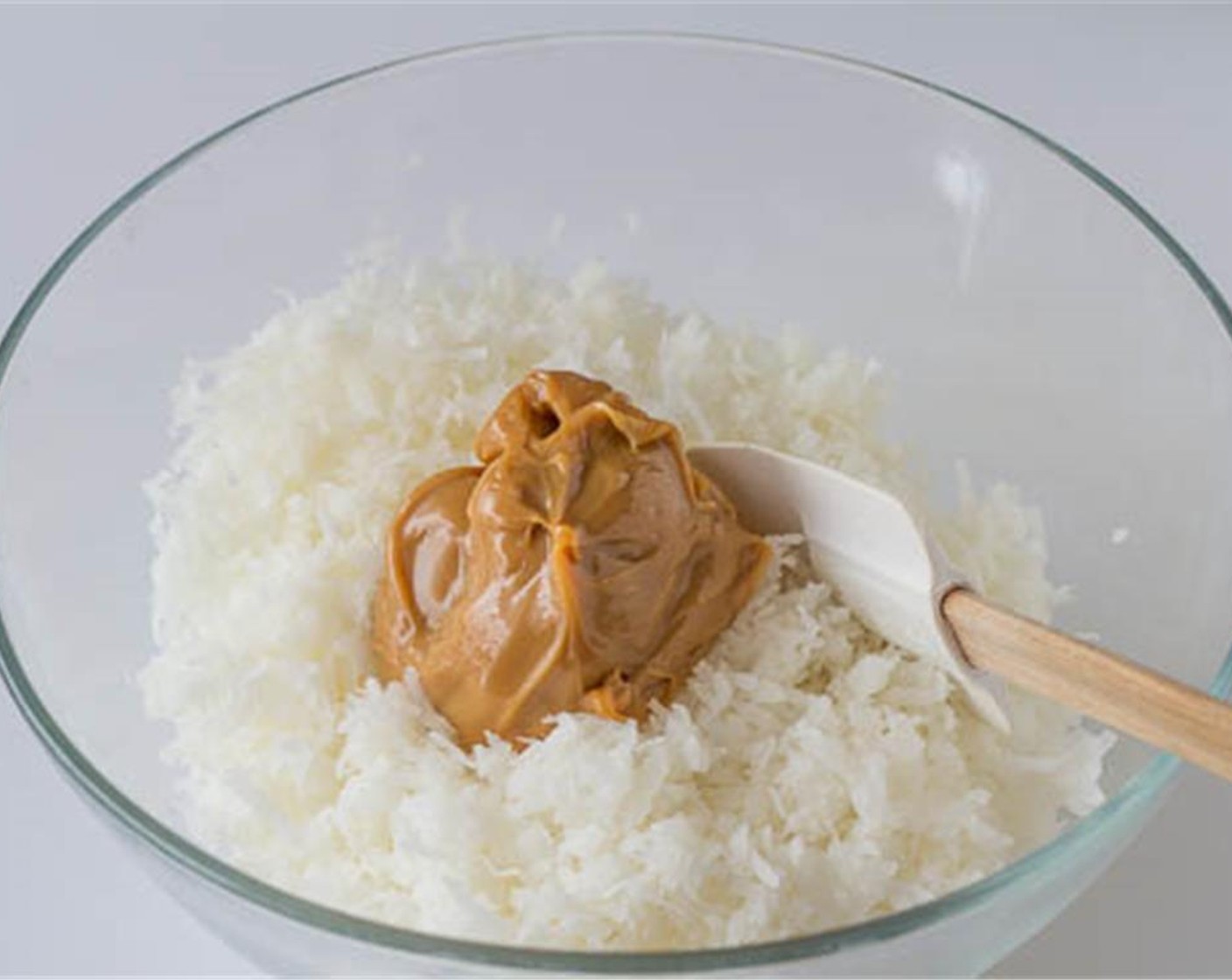 step 2 In a large bowl, mix together Sweetened Shredded Coconut (5 cups) with Dulce de Leche (1/2 cup) until well combined.