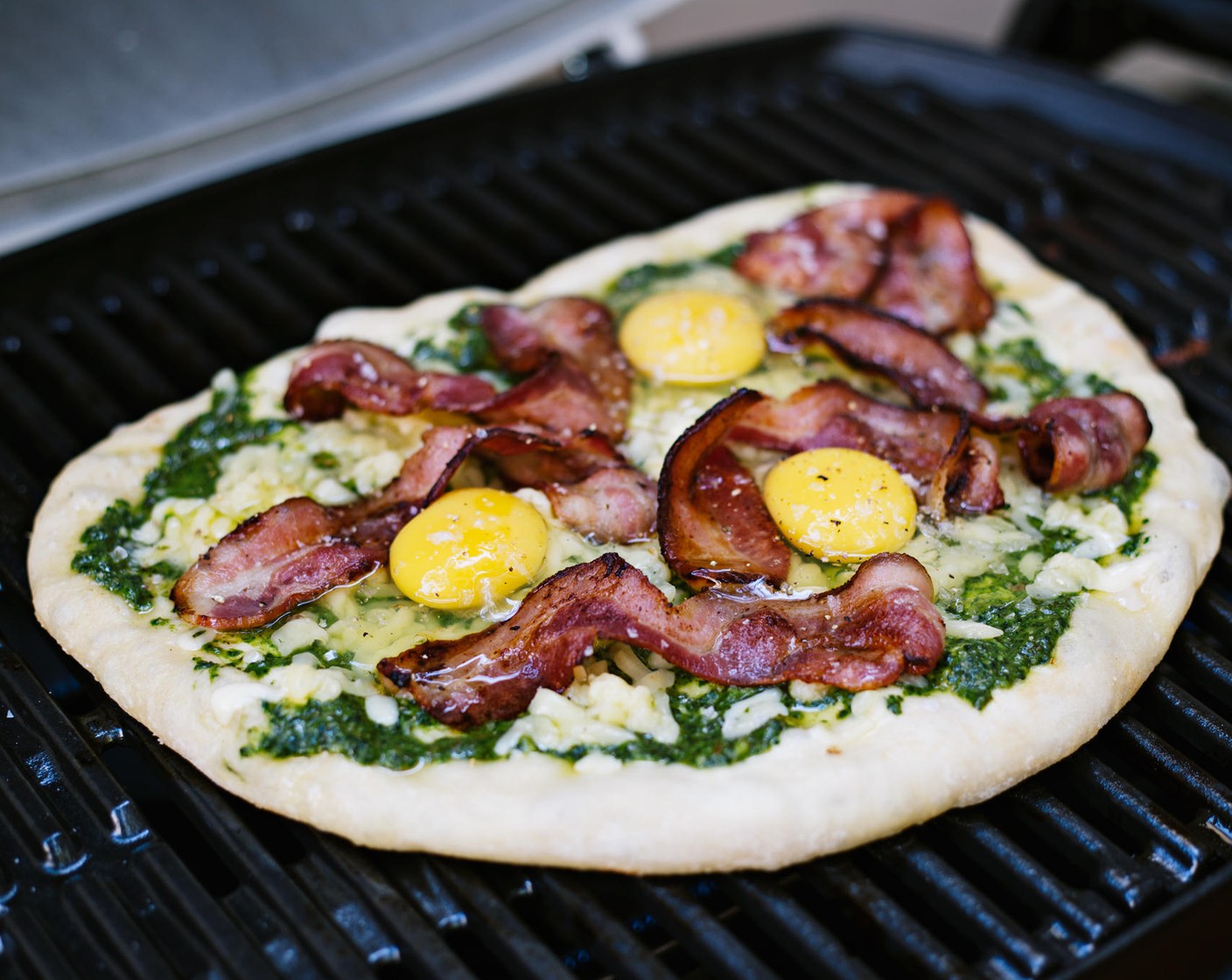 step 8 Carefully crack Eggs (3) onto the pizza, one at a time. Add Kosher Salt (to taste) and Ground Black Pepper (to taste).