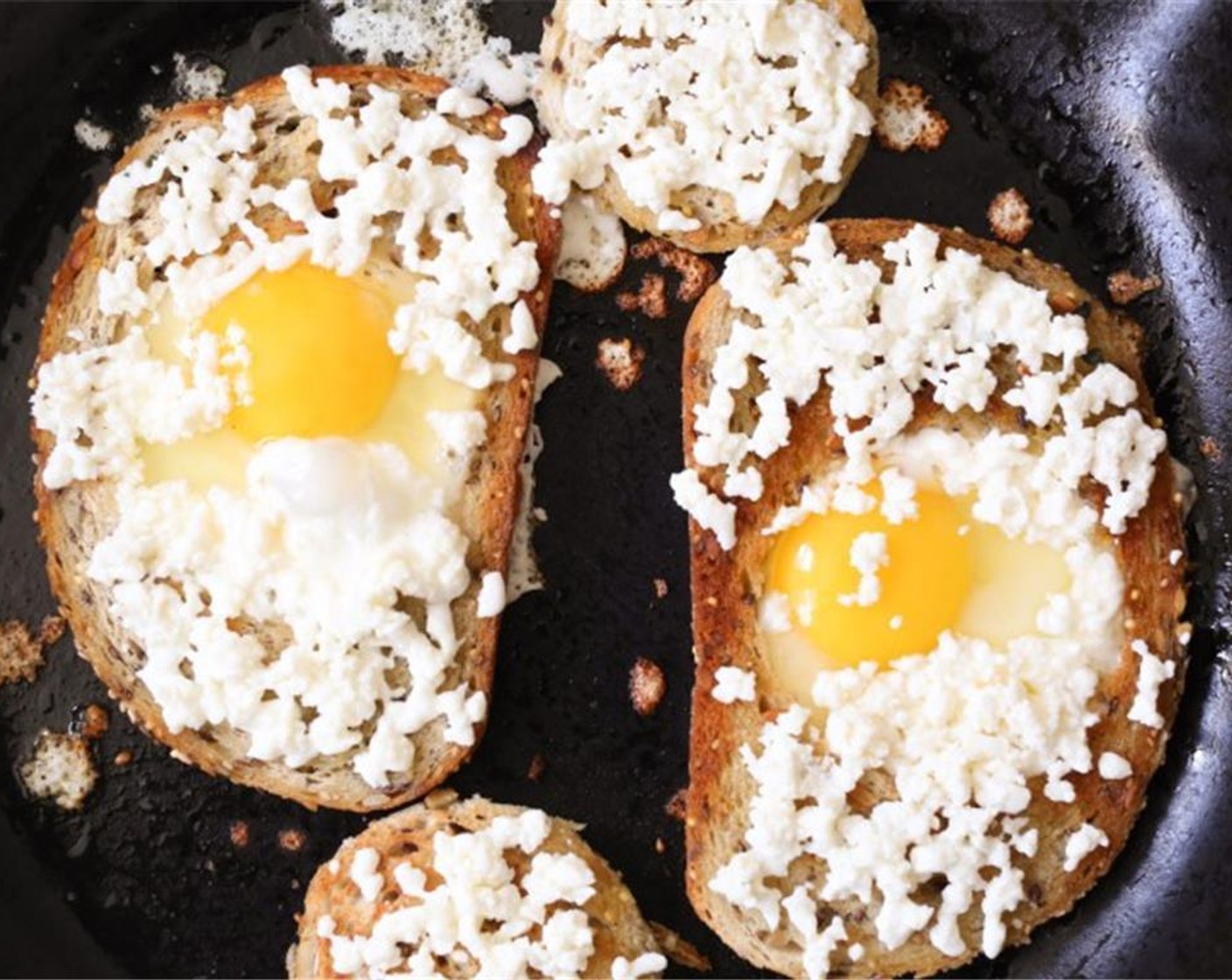 step 4 Flip the bread over and reduce the heat to medium. Crack each Farmhouse Eggs® Large Brown Eggs (2) into a small ramekin and gently pour them into the holes in the bread slices. Immediately sprinkle the bread (including the rounds) and egg with grated Fresh Mozzarella Cheese Ball (1/2 cup).