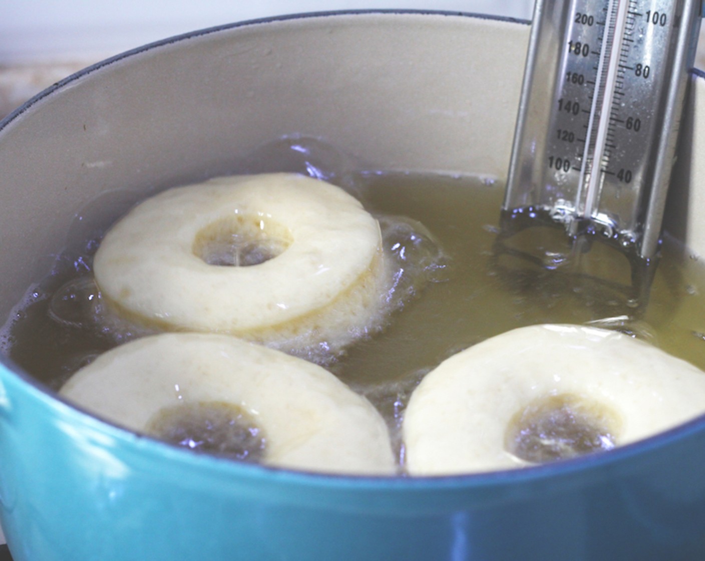 step 17 Carefully fry around 3-4 doughnuts at a time, making sure you don’t crowd the pot as this will mess with the temperate of the oil. Cook for around 2 minutes on each side, until a deep golden brown. Transfer to a wire rack and allow to cool.