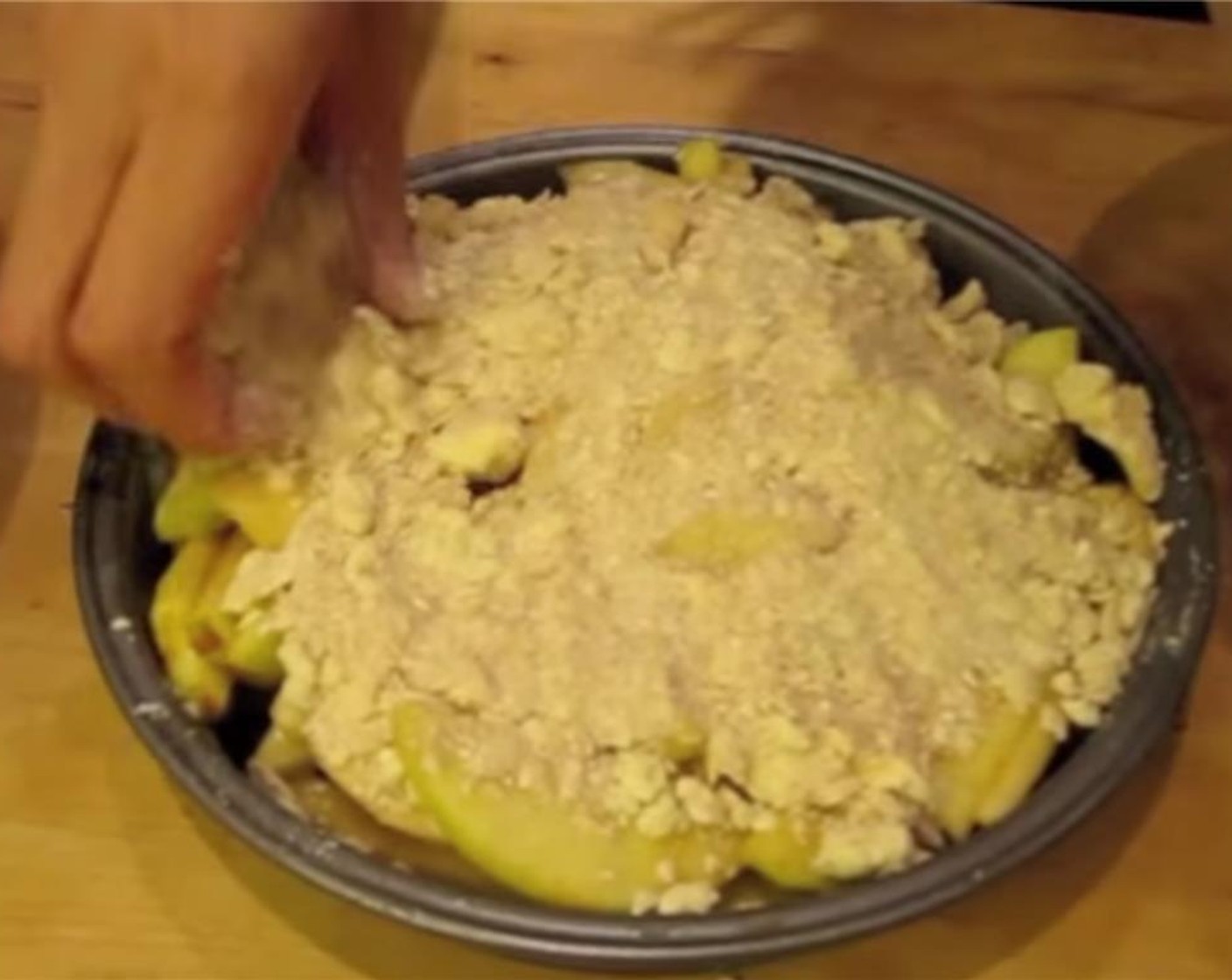 step 8 Add apples to a baking pan and top with the crumble mixture.