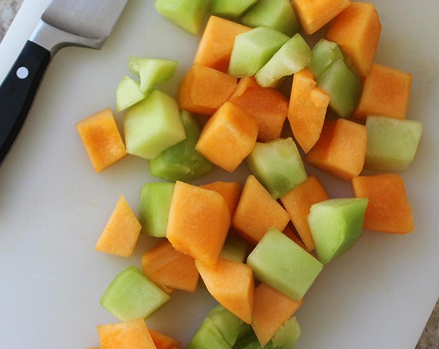 step 3 Meanwhile, place half the Cantaloupes (3 cups) and Honeydew Melons (3 cups) on a large, flat platter, and place the other half on a large cutting board.