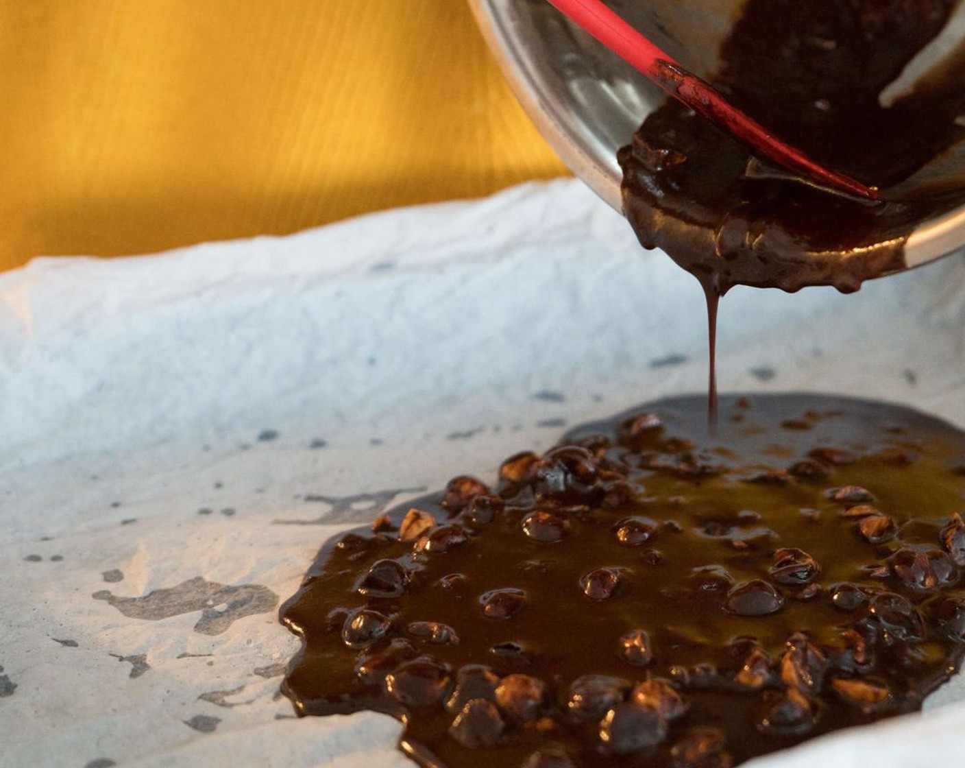 step 5 Pour chocolate mixture on to parchment paper. It should be liquid and very easy to spread.