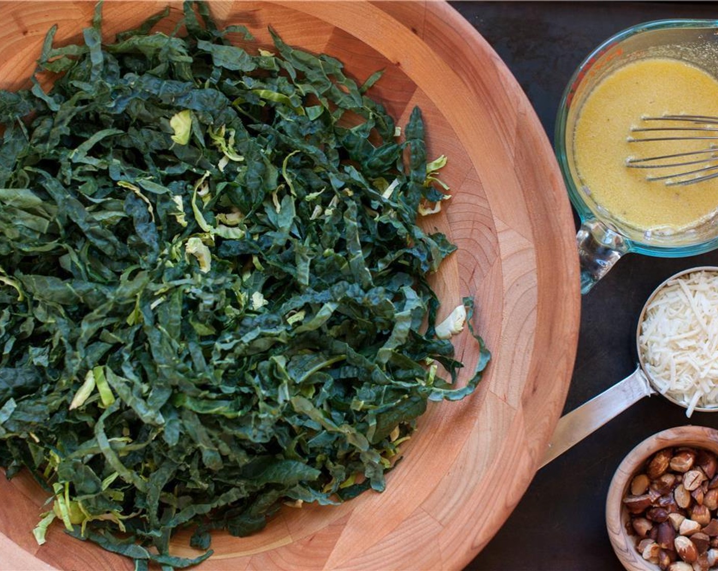 step 5 In a large salad bowl, mix together the kale and the brussels sprout. Add 1/2 of the dressing to the greens and massage the dressing into the greens.