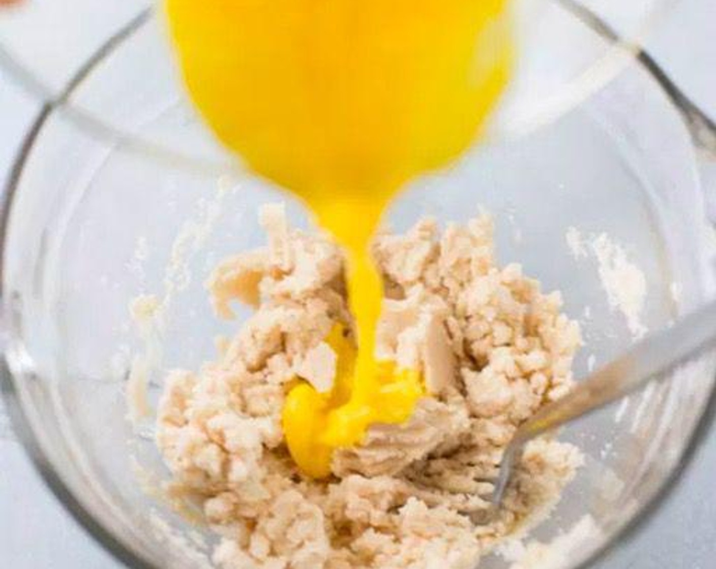 step 4 Mix the Distilled White Vinegar (1/2 tsp) with the Eggland's Best Classic Egg (1). Pour egg mixture into dough mixture and combine with your hands until a ball forms.