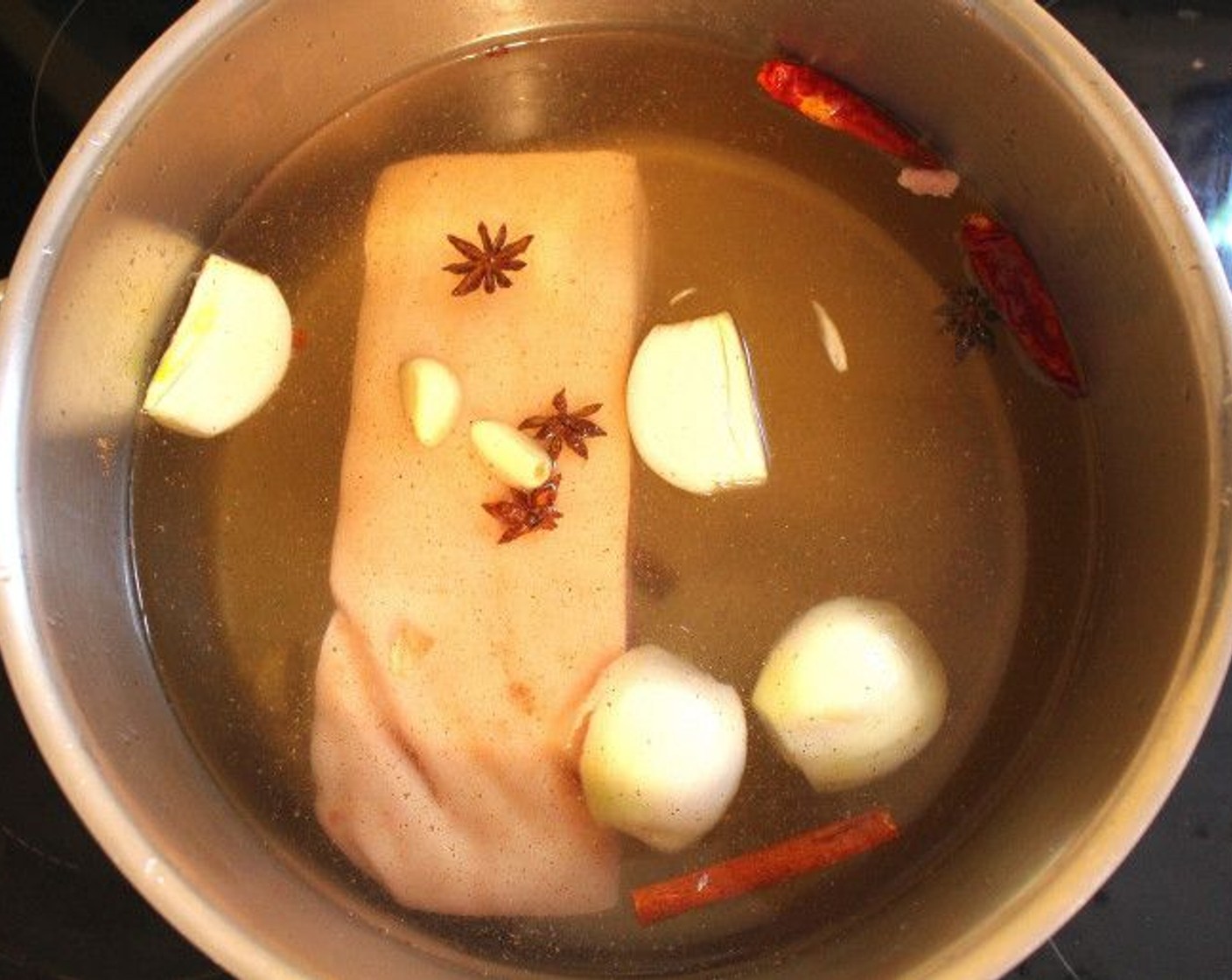 step 1 To a pot, add in Water (16 cups), Onion (1), Garlic (2 cloves), Star Anise (4), Cinnamon Sticks (2), Dried Chili Peppers (2), and Kosher Salt (to taste).