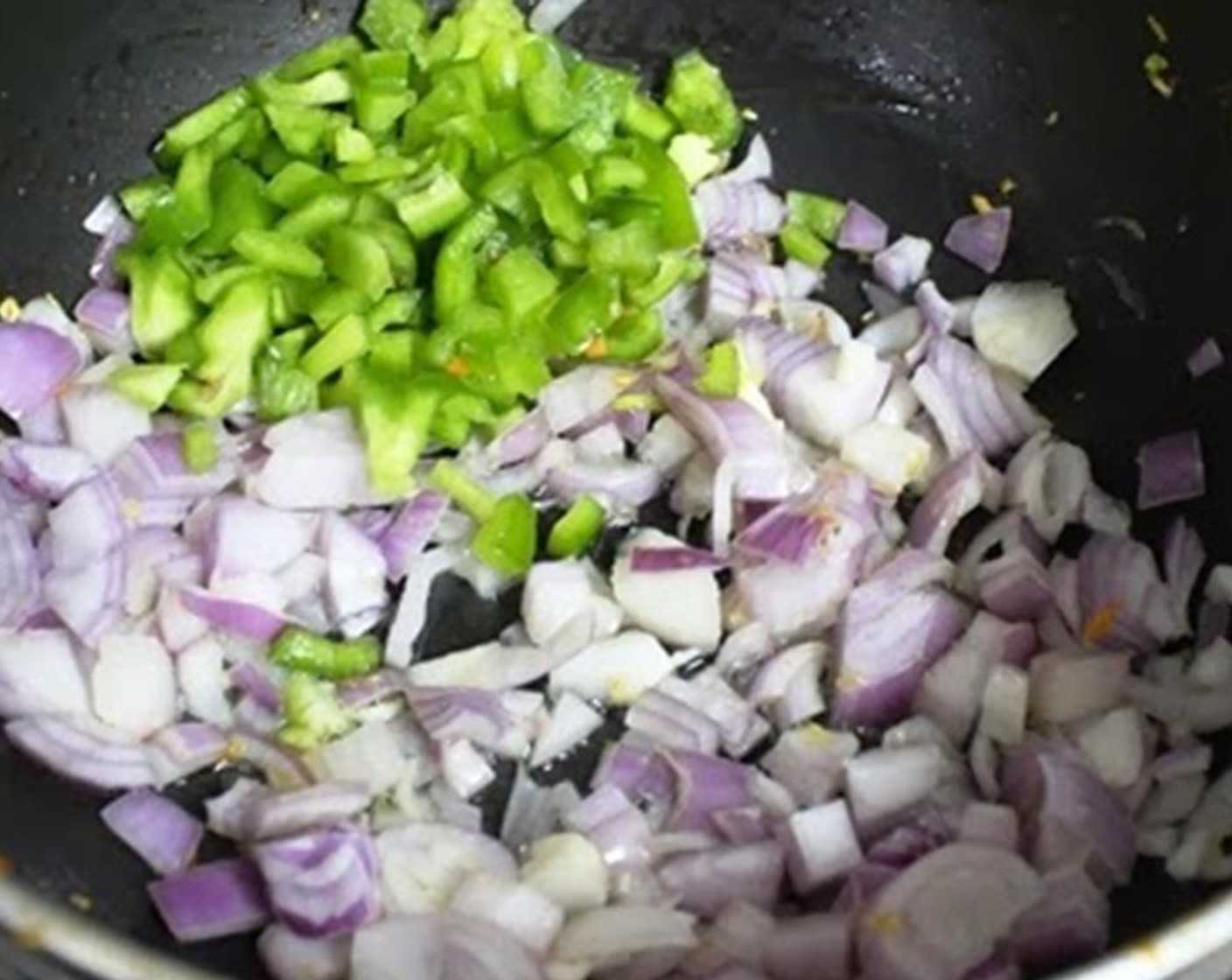 step 5 Quickly add in the white part of the scallions and Bell Pepper (1 cup). Stir well and let that cook on high flame for about 1-2 minutes or until the onions are slightly translucent.