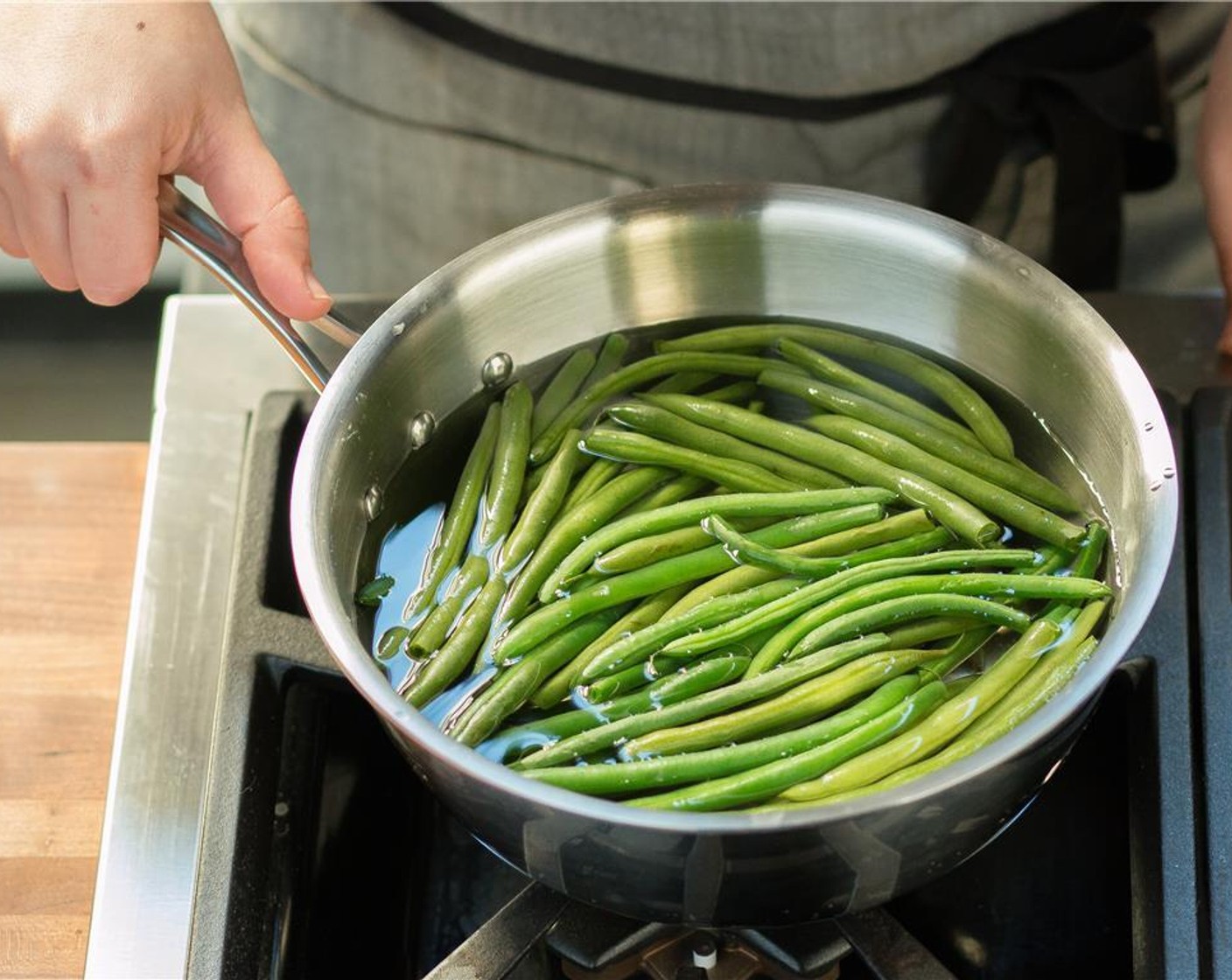 step 13 Increase the saucepot to high heat and boil the water. Once the water is boiling, trim the ends of the Green Beans (1 1/2 cups) and add to the sauce. Cook for 7 minutes, drain, and return to the saucepot.