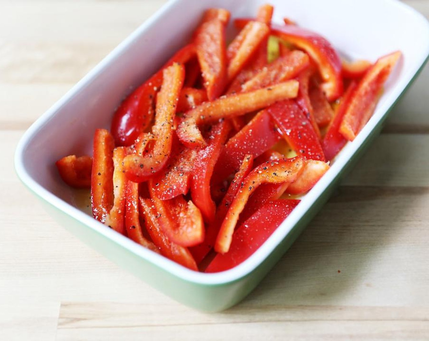 step 2 Cut the top of the Red Chili Peppers (1 1/2 cups) off and discard. Slice up the rest of the pepper into strips and place in a baking dish. Drizzle with Olive Oil (3.5 oz), Salt (1 1/4 tsp), and Ground Black Pepper (to taste) place in the oven to roast for around 30-45 minutes.