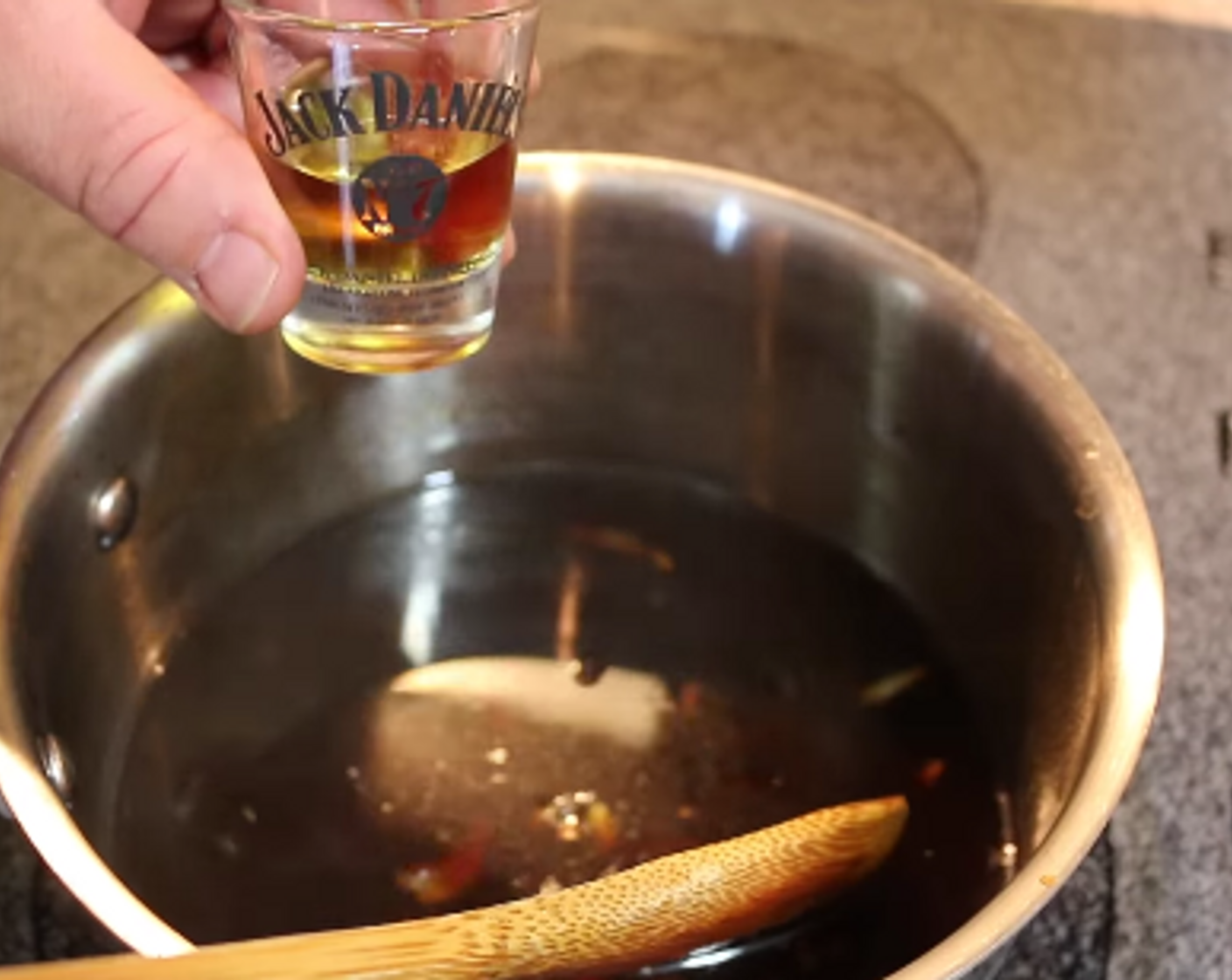 step 8 Mash the roasted Garlic (4 cloves) with a fork and add to the pot along with the Lemon (1), Pineapple Preserves (4 Tbsp), and Jack Daniels Whiskey (2 fl oz). Continue to reduce for 10 minutes.