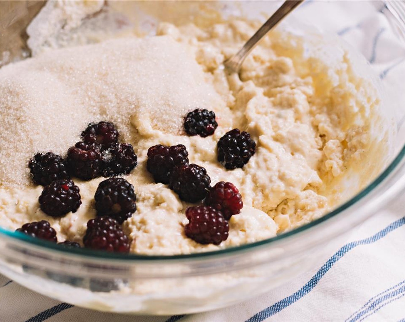step 7 When almost fully incorporated, gently stir in the  Granulated Sugar (1/2 cup) and Boysenberries (1 cup).