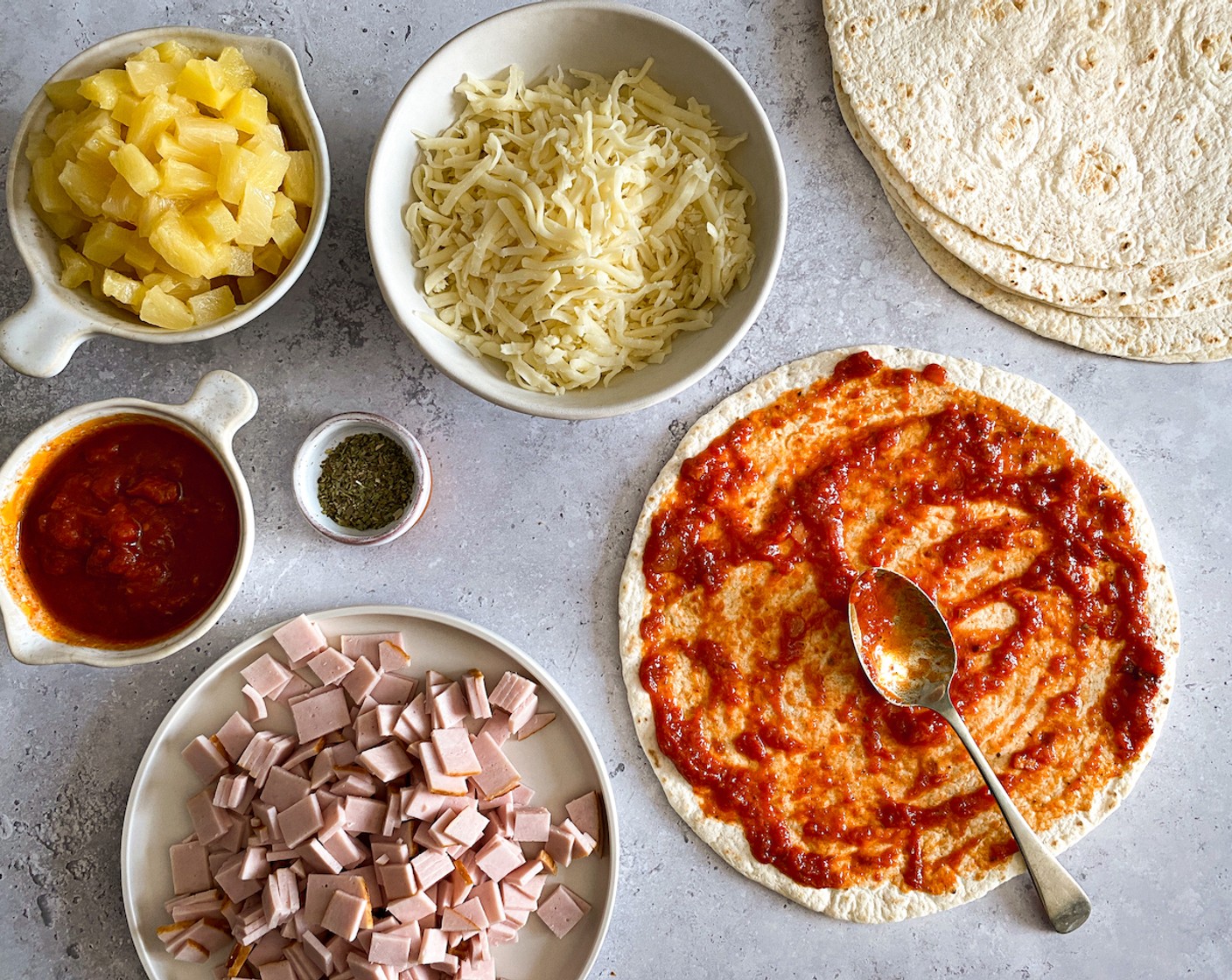 step 2 Spread a heaped tablespoon of Pizza Sauce (1 jar) onto each 9-Inch Flour Tortillas (8).