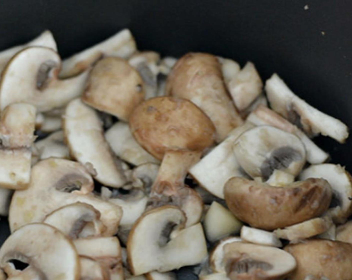 step 2 Sauté the mushrooms, Garlic (1 clove), and Onion (1 Tbsp) in Oil (1 Tbsp) for a couple of seconds until softened.