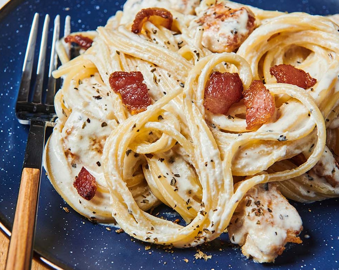 step 3 Cut the bacon into bite-size pieces. Add to the skillet. Place the spaghetti in a serving bowl. Add the chicken mixture; toss well. Serve immediately.