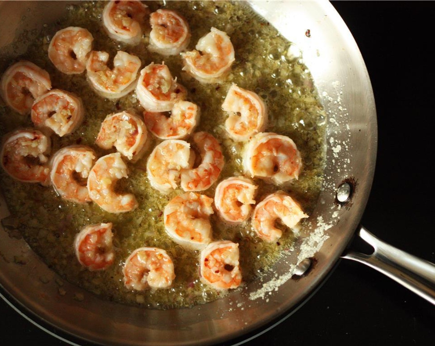 step 4 Add the shrimp, Salt (3/4 tsp) and Ground Black Pepper (1/2 tsp) to the frying pan and sauté for 3-4 minutes until the shrimp is pink and opaque on both sides.