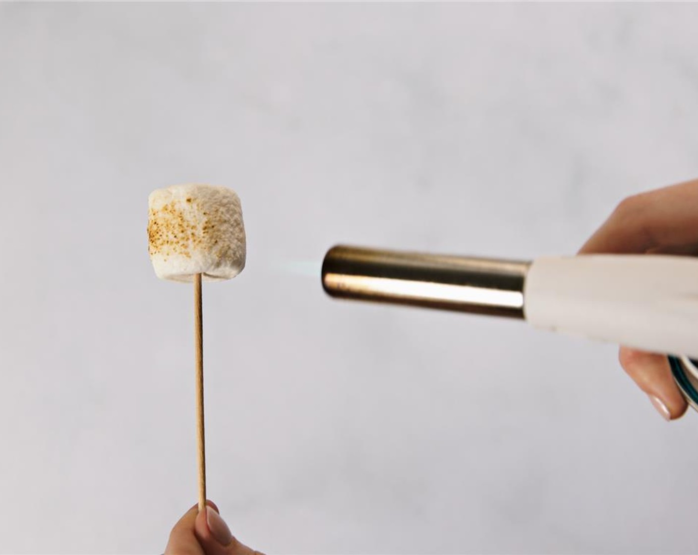 step 2 Using a blowtorch, brown the marshmallow to desired degree of crunchy and golden.