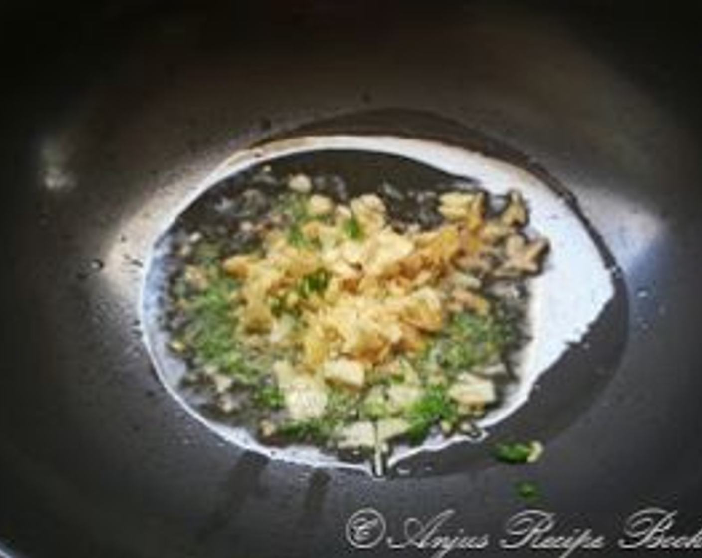 step 6 To a pan pour Olive Oil (2 Tbsp) and add Fresh Ginger (1 tsp), Garlic (1 tsp), and Red Bell Peppers (2 Tbsp). Saute for a minute.