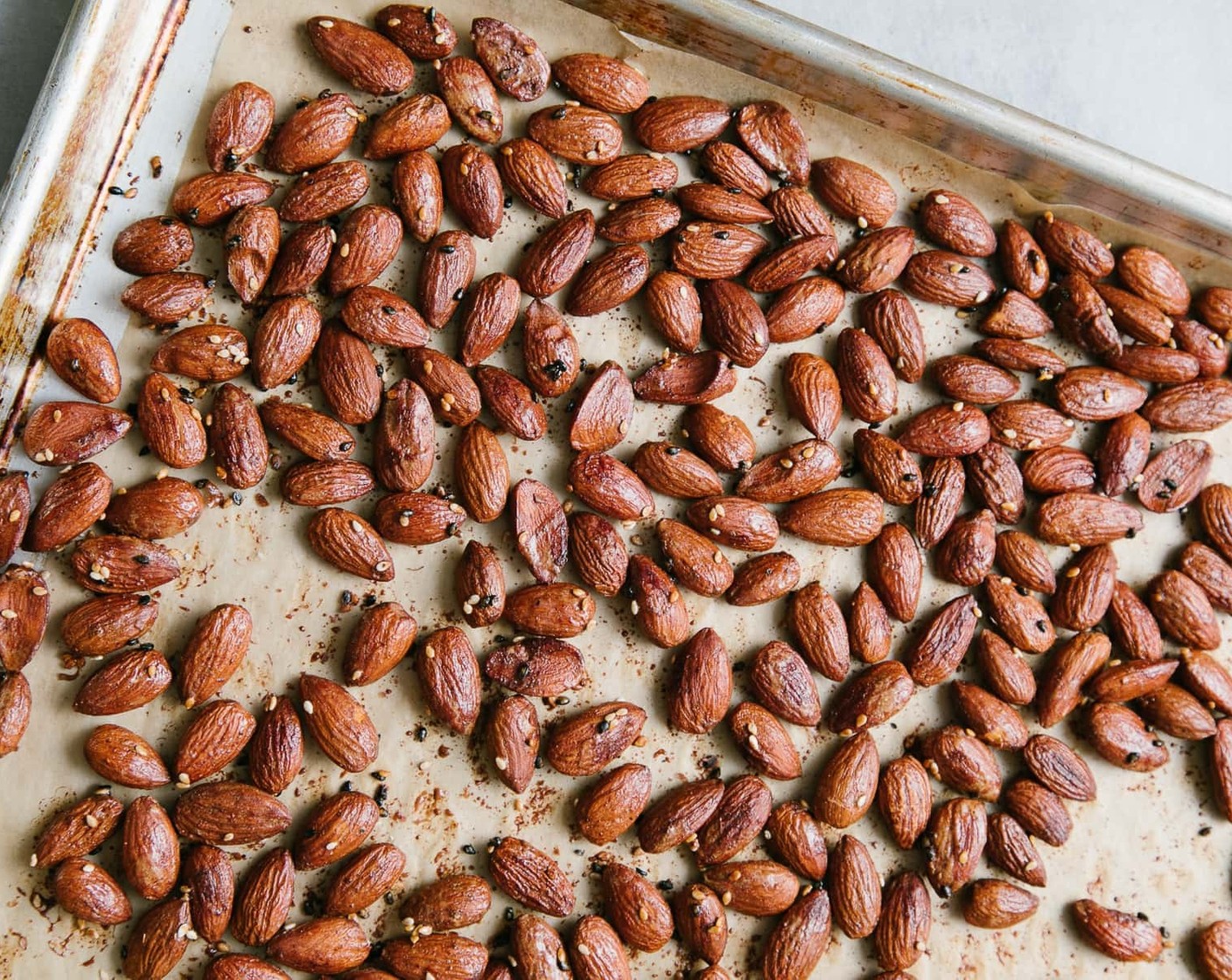 step 4 On a large baking sheet (a rimmed one would be ideal), spread mixture in an even layer. It's ok if some almonds clump up. You may even like to sprinkle a little salt on top of the almonds for a little extra saltiness!