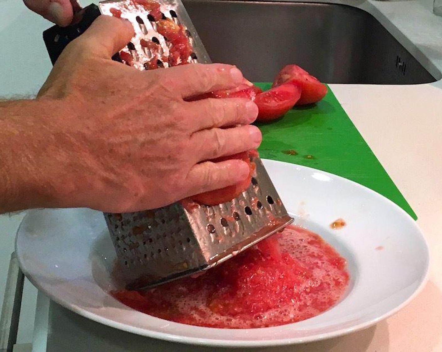 step 2 Cut Tomatoes (5 cups) in halves or quarters and remove tough cores. With the skin side against your palm, grate the tomato over the large holes of a box grater.