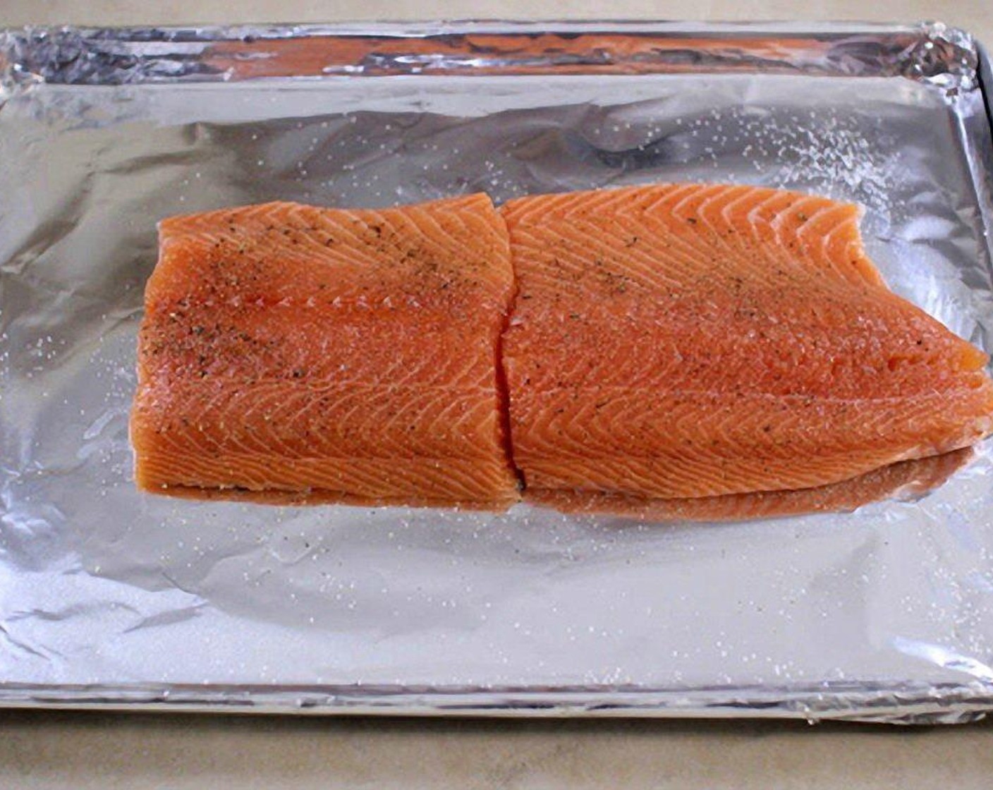 step 2 Line a rimmed baking sheet with aluminum foil. Place the Salmon Fillets (2 lb) on the prepared baking sheet.