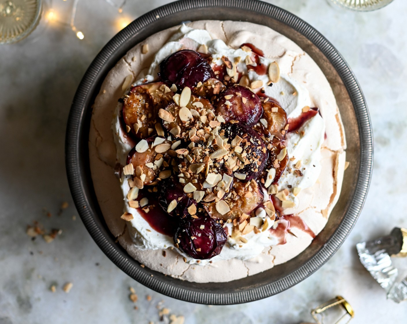 step 9 Once cooled, whip the Whipping Cream (2 cups) to the stiff peak stage and spoon liberally over the top of the pavlova. Carefully arrange the nectarine halves over the cream and spoon over any syrup left in the roasting dish.